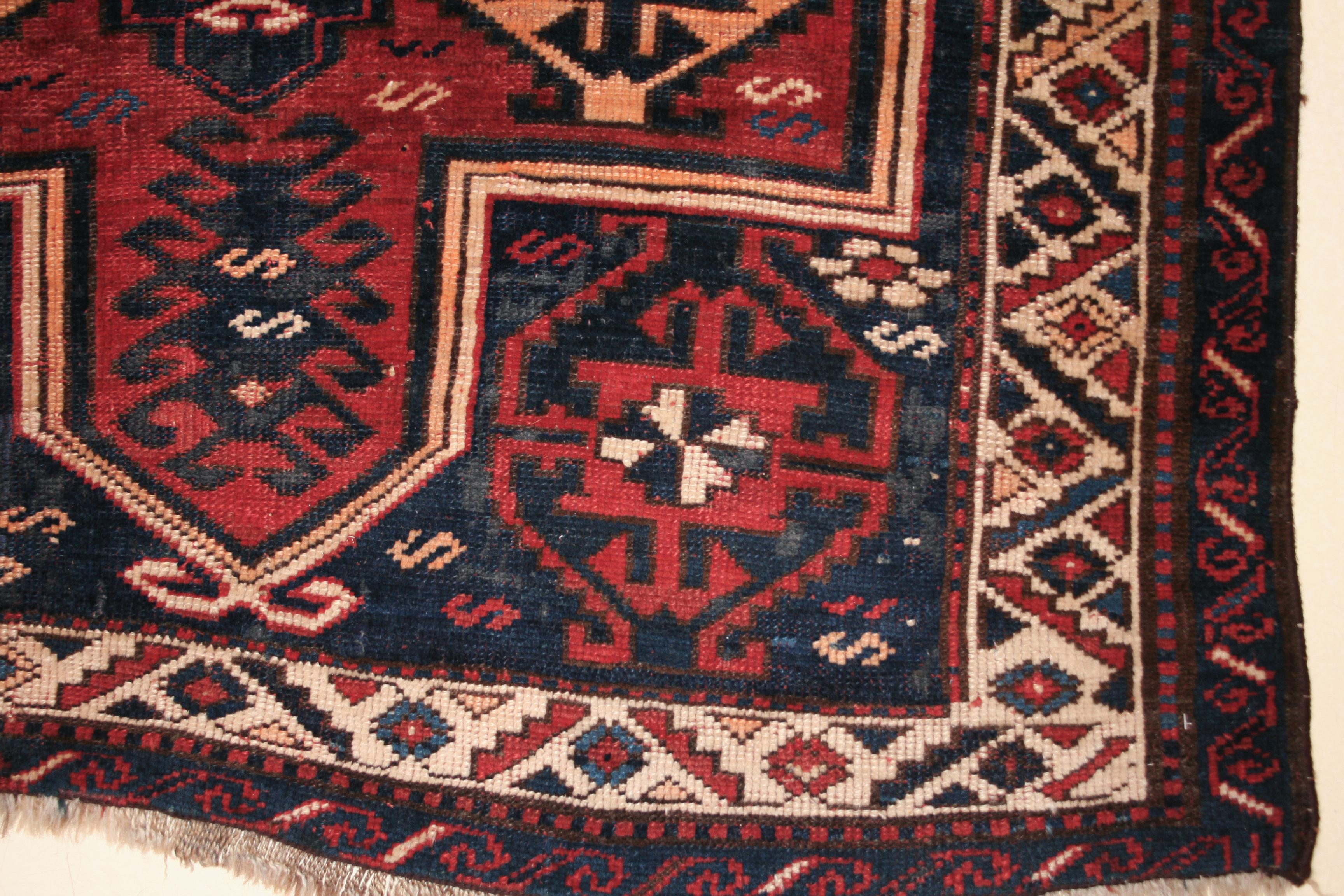 An antique southwest Caucasian rug, belonging to the prestigious family of weavings known as Kazak. These are characteristically distinguished by abstract geometric patterns originating from the ancient iconography of the Armenian people, who