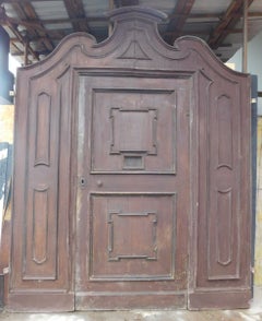 Antique double-sided entrance door in carved walnut, 18th century Italy