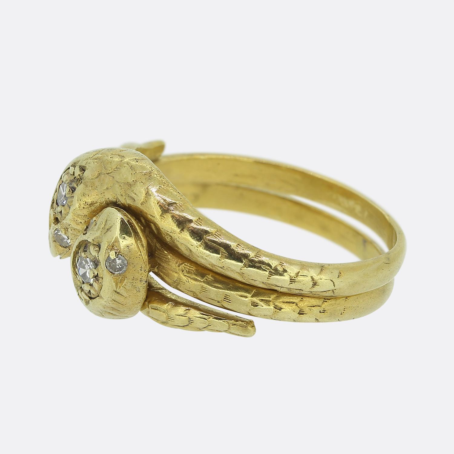 Here we have an exquisite double snake ring taken from the early stages of the 20th century. This antique piece has been handcrafted from 14ct yellow gold with meticulous attention to detail. The ring portrays two individual entwined snakes, which