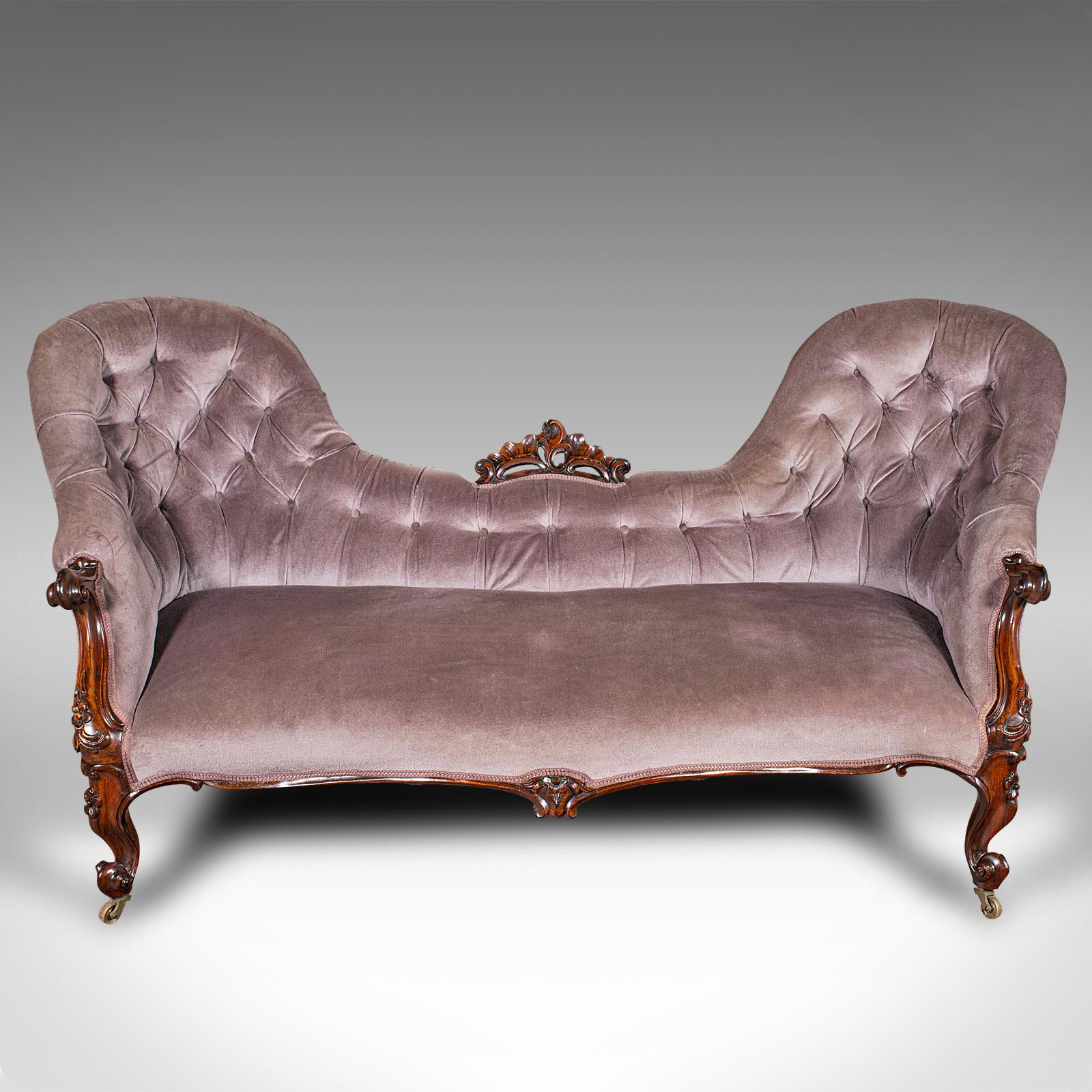 This is an antique double spoon back settee. An English, rosewood three seater ornate sofa, dating to the early Victorian period, circa 1840.

Striking form and a treat of carved craftsmanship
Displays a desirable aged patina and in good order