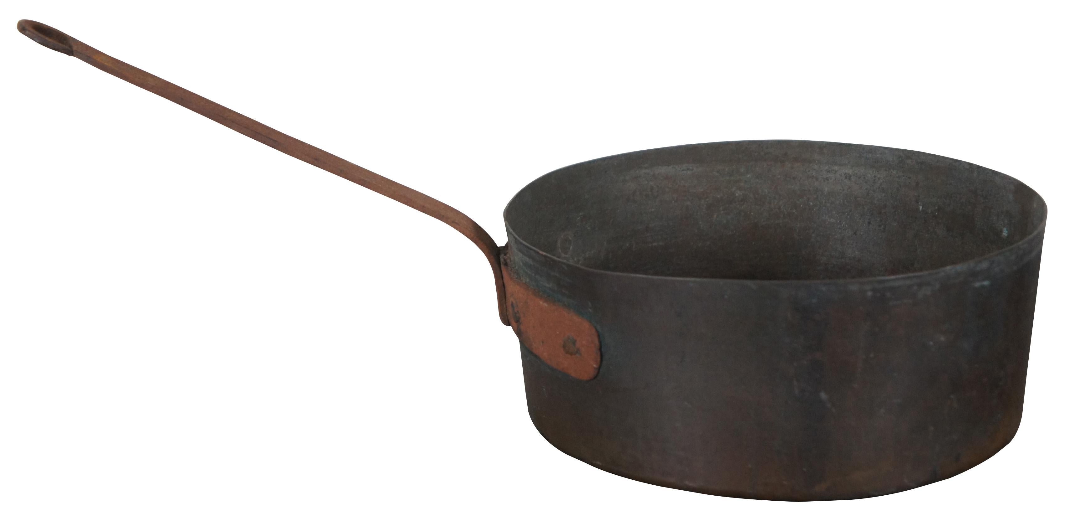 Antique copper sauce pan with cast iron handle, stamped “V.H.M.” on the side; capacity approximately 5 quarts.

Measures: 18” x 9.5” x 4.25” / handle height – 7.25” (Width x depth x height).
  