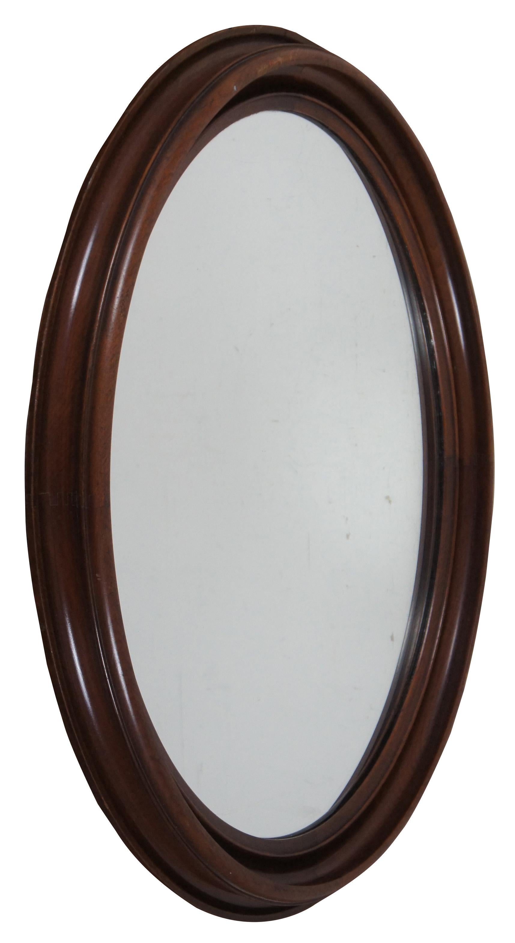Antique mahogany wall mirror with deeply beveled oval frame and dovetailed joinery.

Measures: 23.5” x 1.75” x 27.5” / sans frame - 18.5” x 22.25” (width x depth x height).
 