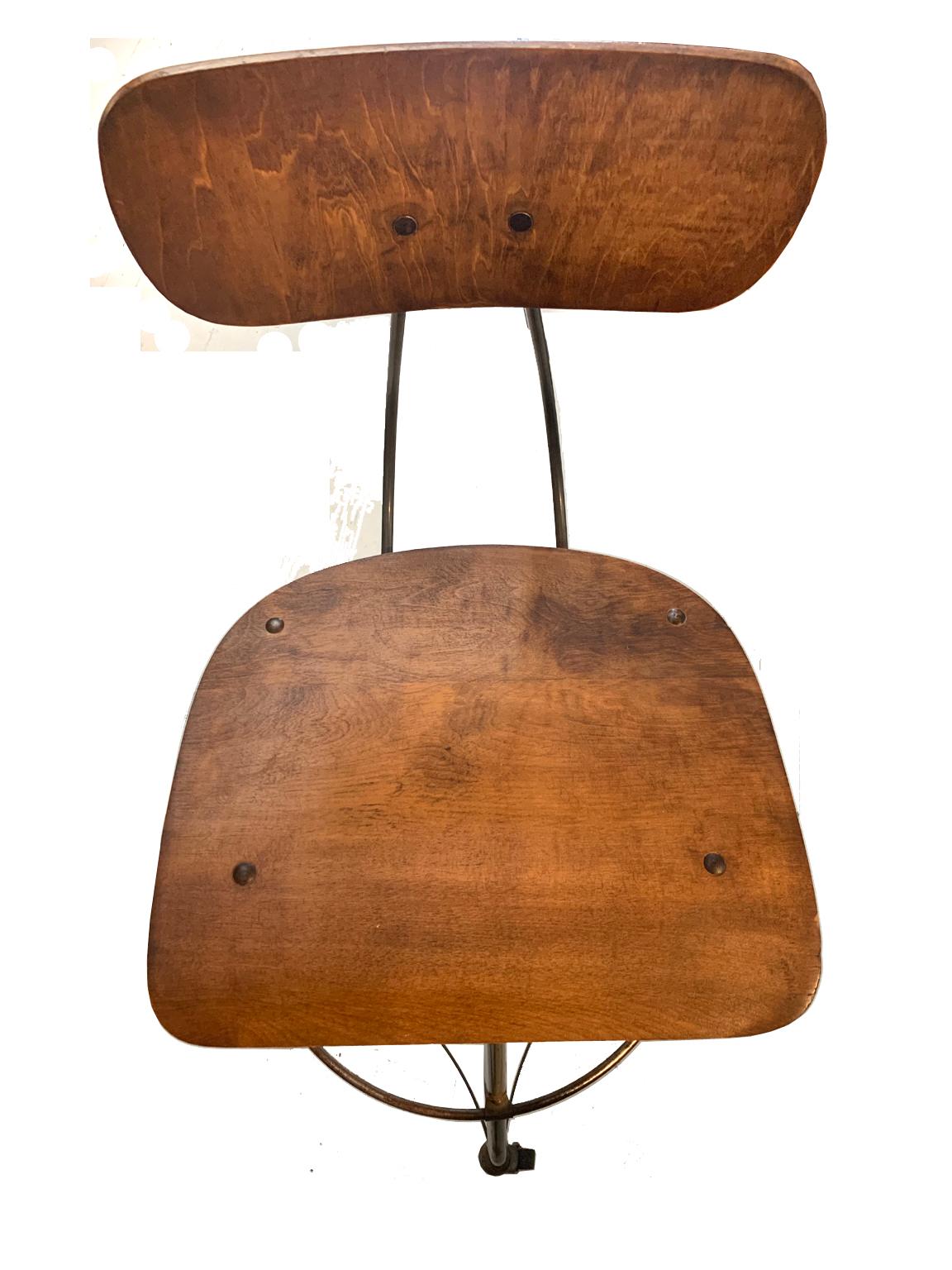 Antique drafting adjustable stool with rolling casters. Made by Toledo Chair Company. This stool is in great condition, casters roll clean and adjustable mechanics works well too. The wood is original and well kept. These stools are built to last