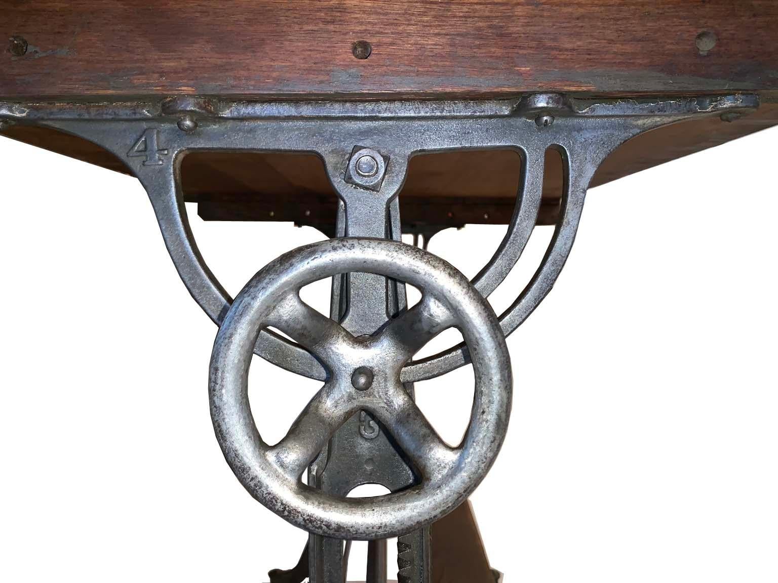 A fantastic find, a large functional drafting table with iron base, this piece is in perfect functional condition. The adjustable wheels are smooth. The base is tight and stabile. This is an ideal piece for standing desk or an adjustable island.