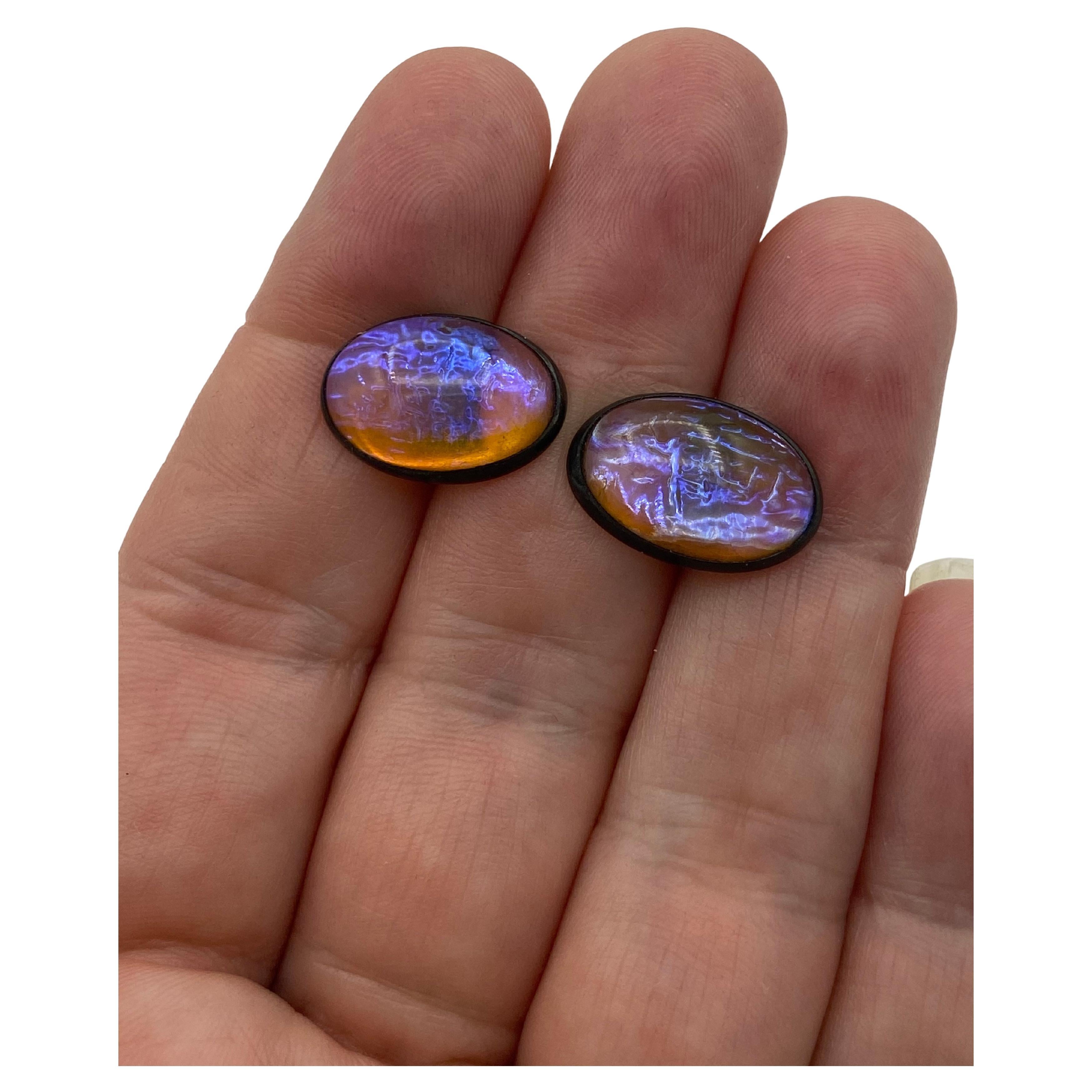 A stunning set of antique jelly opal cufflinks and stick pin in the original box. True antique Jelly Opal art glass, not foil-backed. The oval glass stones are a peachy amber color with a gorgeous violet-blue flash. The jelly opals are set in
