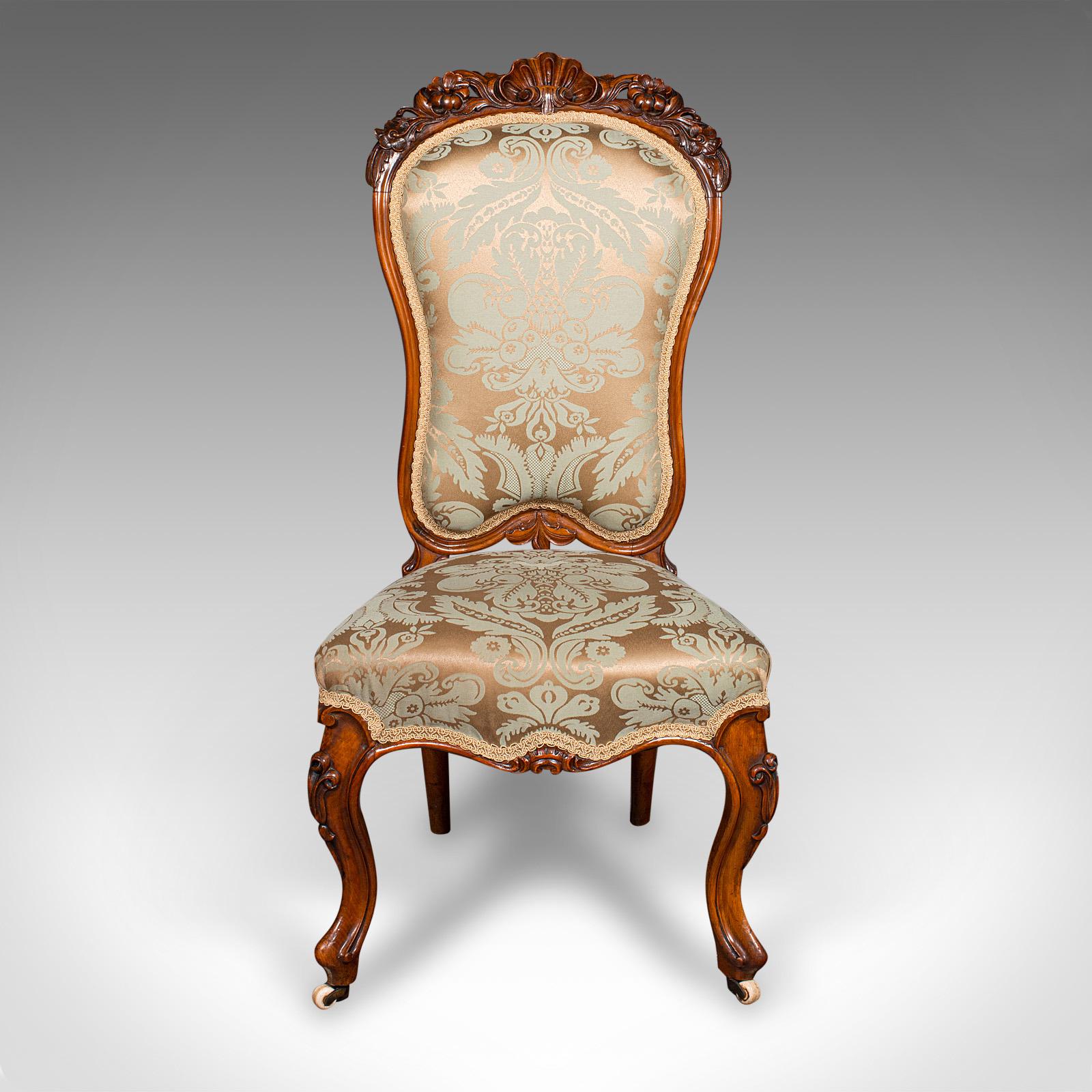 This is an antique drawing room chair. An English, walnut ladies or side seat, dating to the early Victorian period, circa 1840.

Delightfully upholstered chair with a fine decorative appearance
Displays a desirable aged patina and in very good