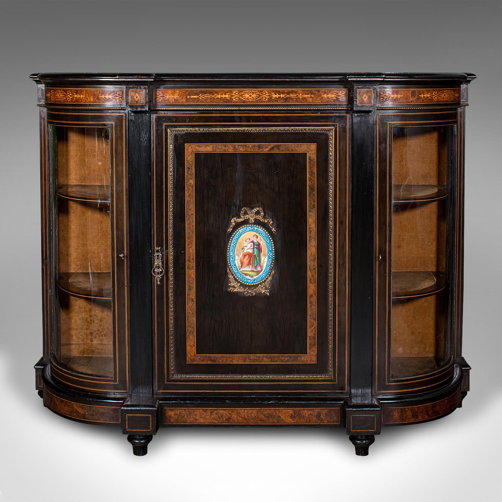 This is an antique drawing room credenza. An English, ebonised walnut and glass display cabinet, dating to the early Victorian period, circa 1850.

Mid-19th century decadence, with an exquisite appearance throughout
Displays a desirable aged patina