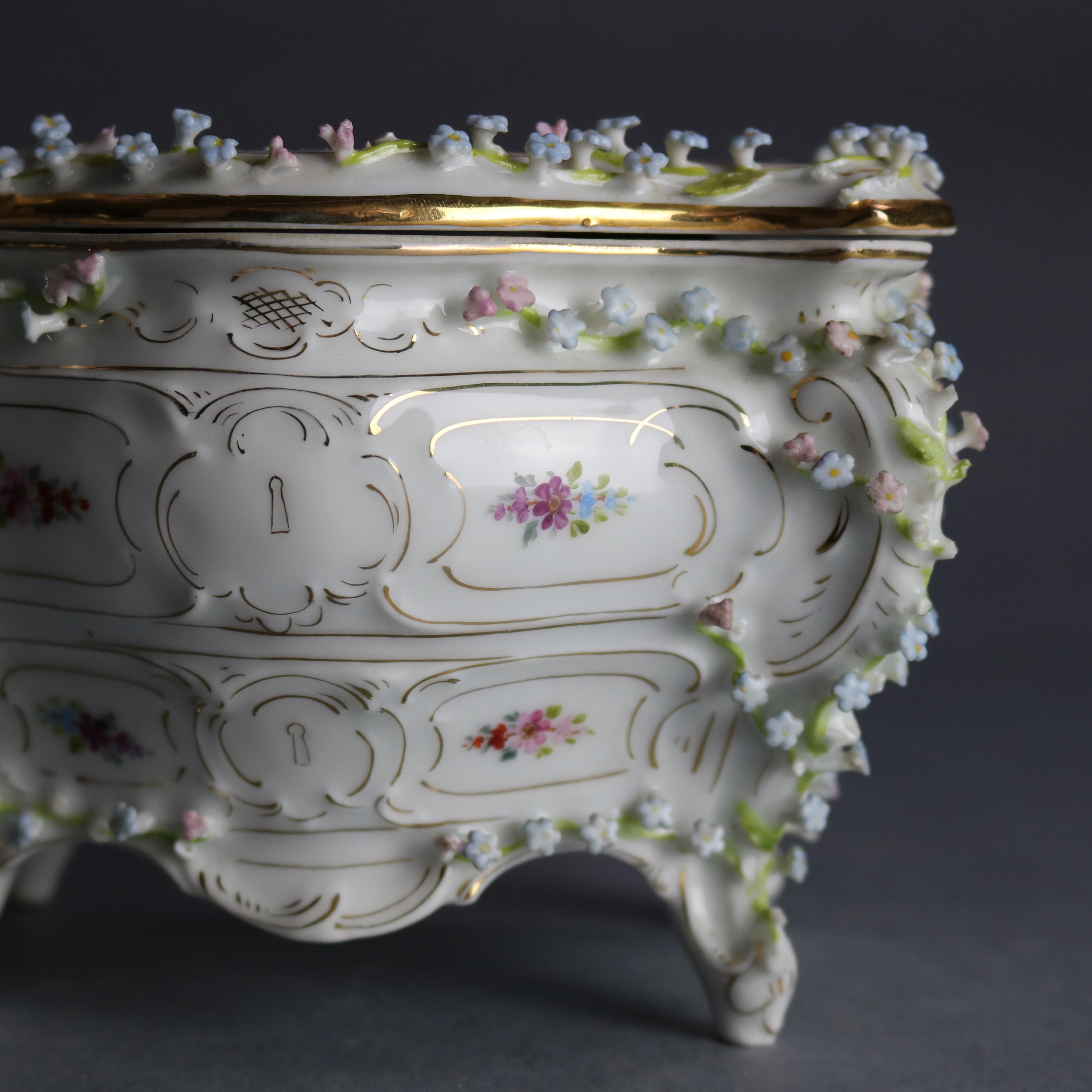 An antique German Dresden dresser box offers bombe chest form with hand painted applied floral elements and gilt highlights throughout, hand numbered on base as photographed, 19th century

Measures: 4.25