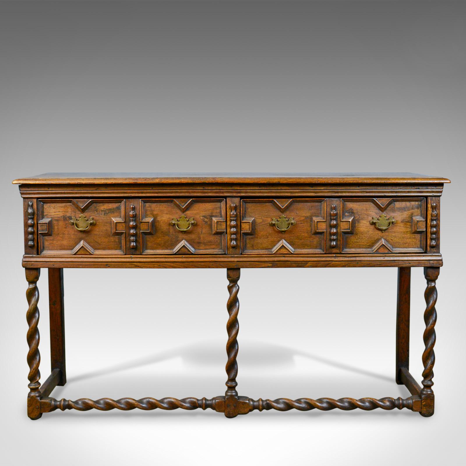 This is an antique dresser base from the early 18th century. An English, oak sideboard dating to circa 1700.

Solidly constructed in oak with desirable color and patina
Displaying wisps of medullary rays in the lustrous wax polished finish
In