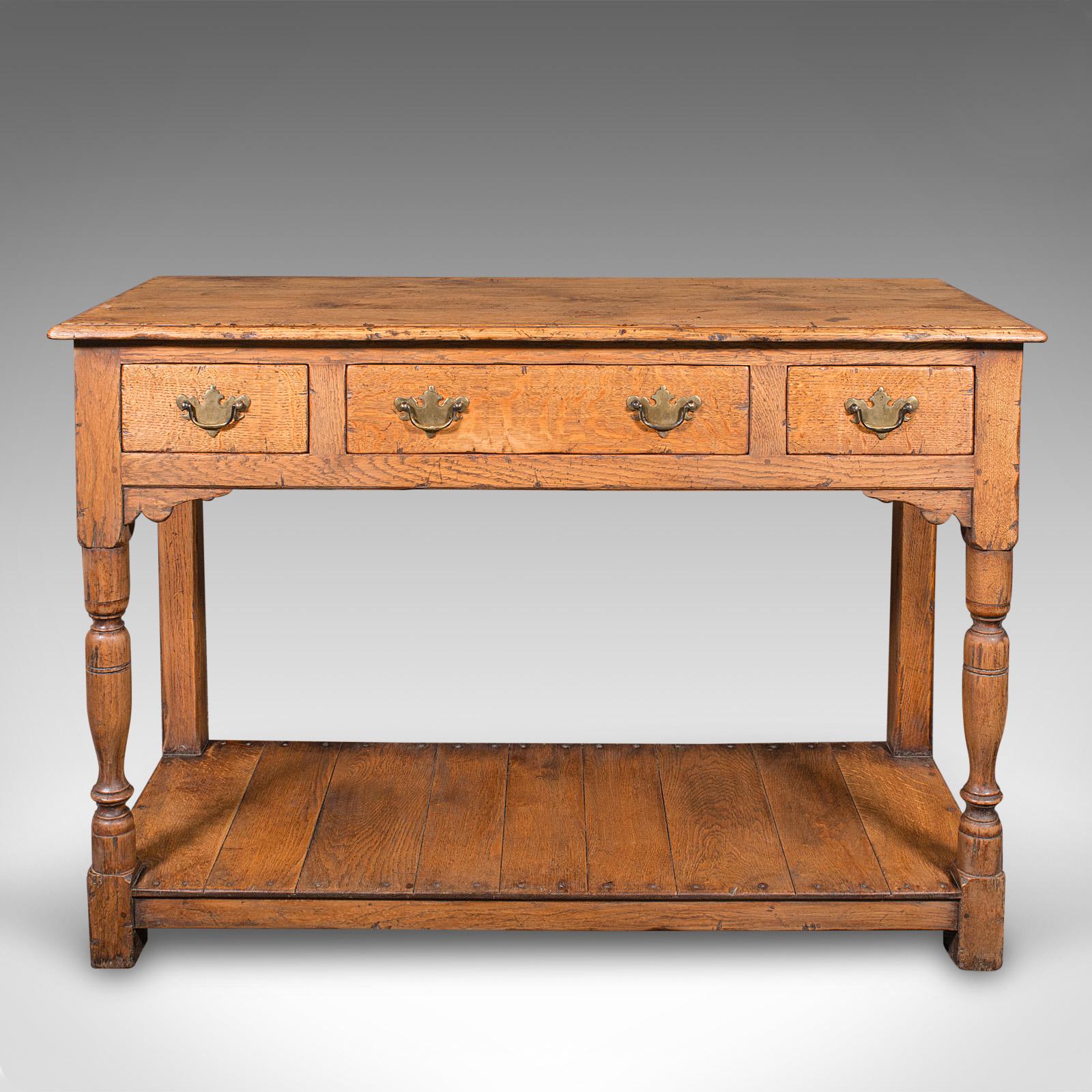 
This is an antique dresser base. An English, oak kitchen sideboard in Georgian revival taste, dating to the Edwardian period, circa 1910.

Appealing revival dresser with lovely colour and robust craftsmanship
Displays a desirable aged patina and in