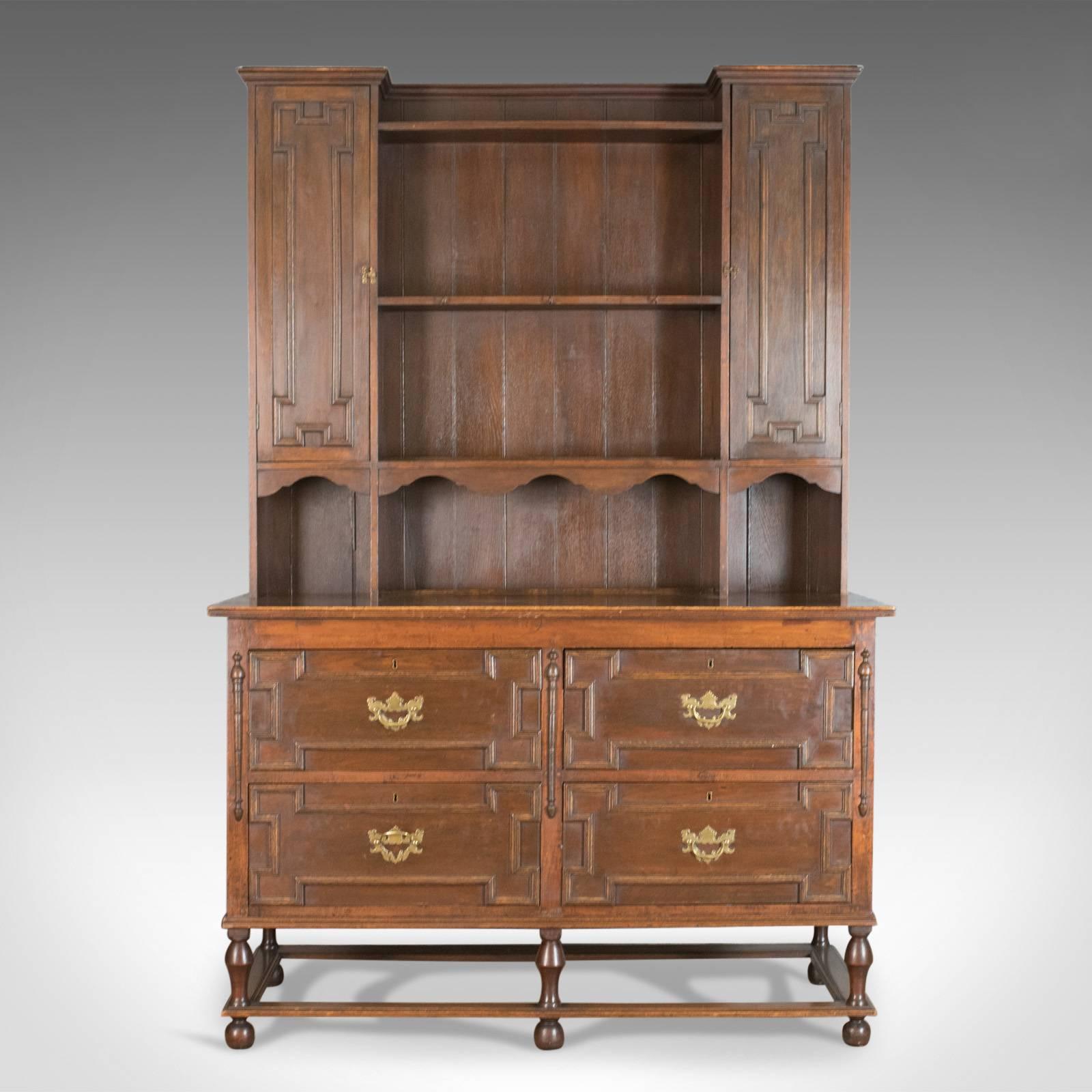 This is an antique dresser, a Victorian country kitchen sideboard in the Jacobean taste. In oak by Snawdon Bros of Exeter and Plymouth and dating to circa 1880.

A Victorian dresser in the Jacobean taste
Good color and grain interest with a