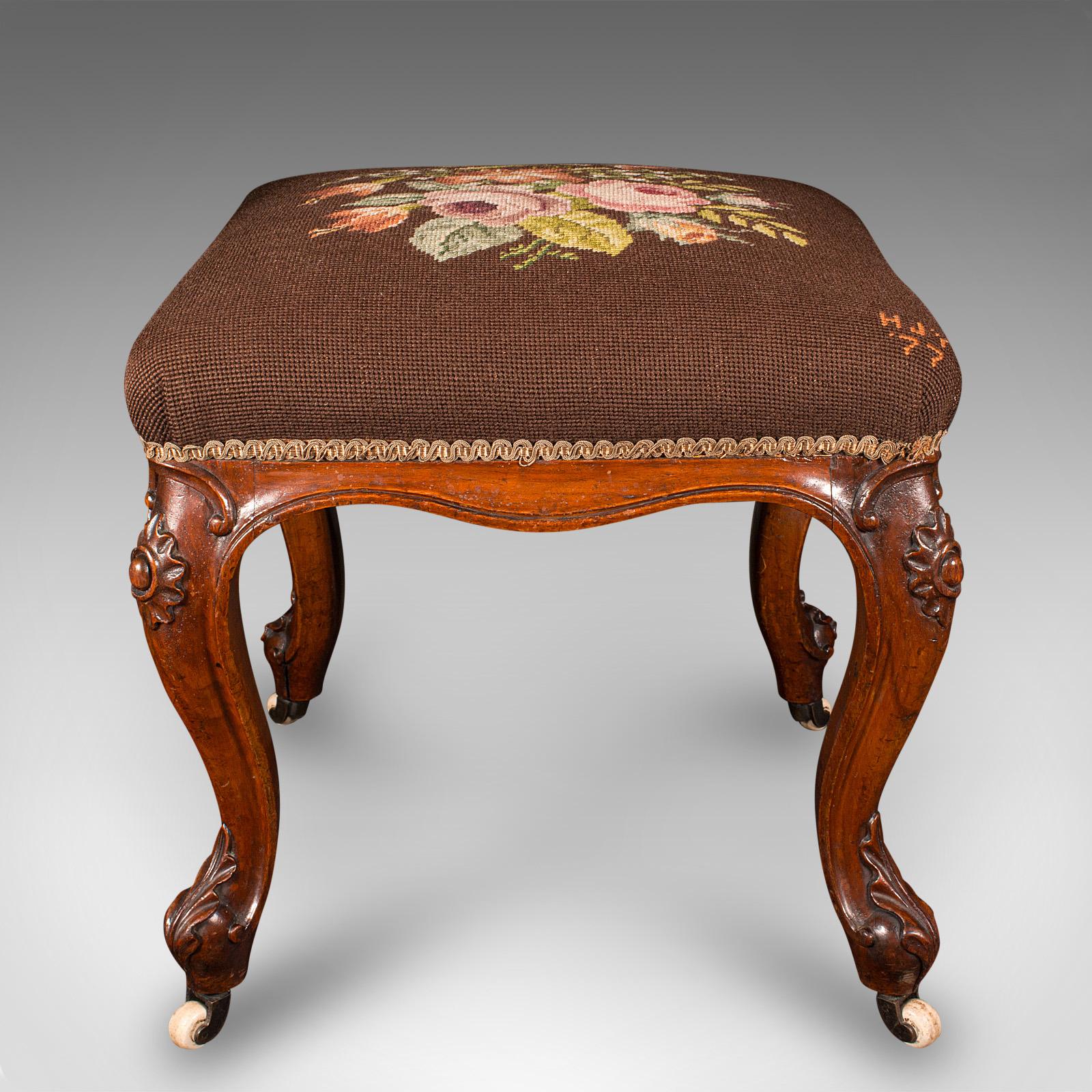 This is an antique dressing stool. An English, walnut and needlepoint footstool, dating to the early Victorian period, circa 1840.

Delightful needlepoint cushion over a finely crafted frame
Displays a desirable aged patina and in good order
Quality