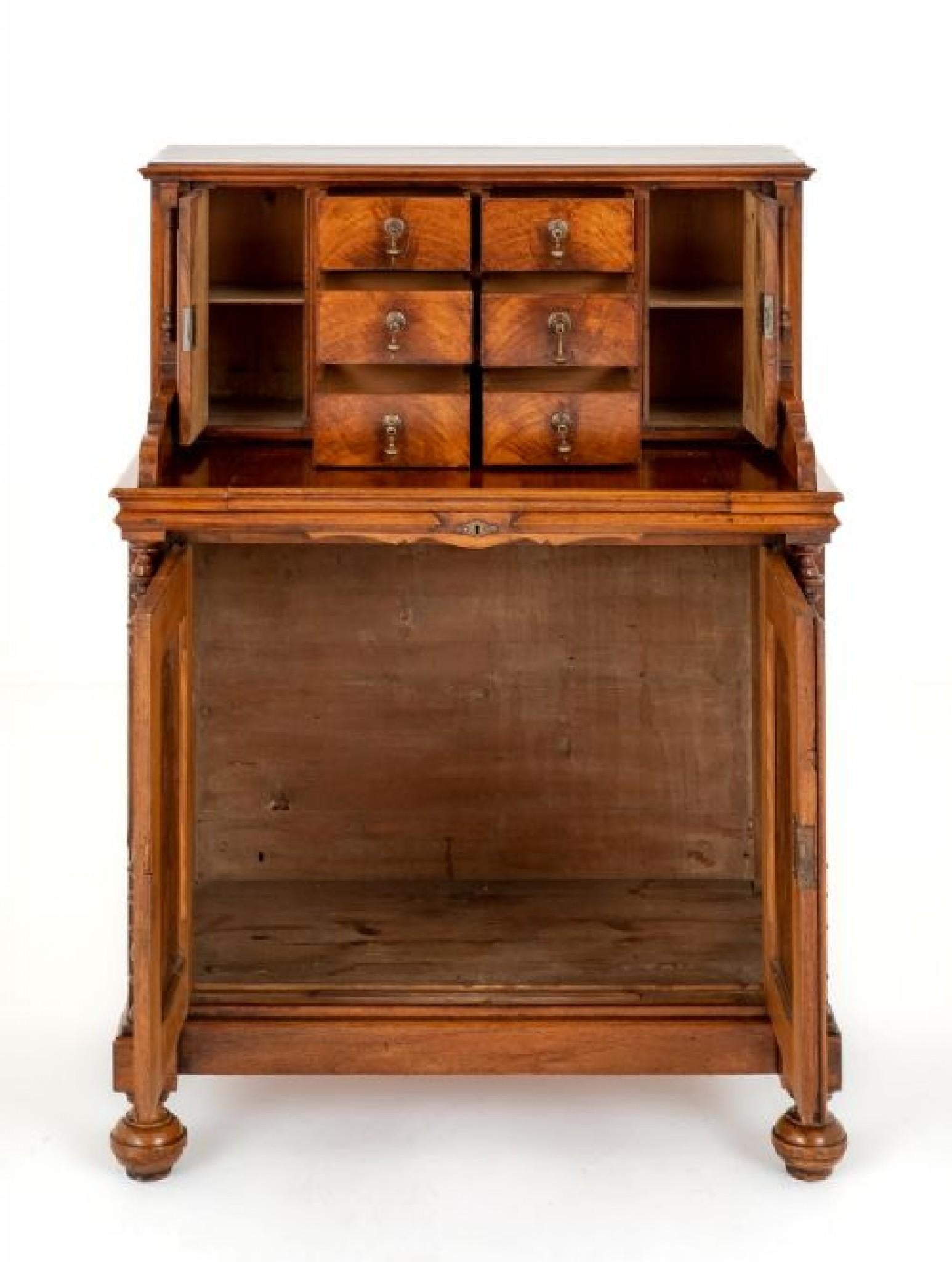 An Unusual French Walnut Dressing Table.
Standing upon Turned Feet.
Circa 1880
Featuring 2 Paneled Doors Flanked by Turned Columns.
The Upper Section Having 6 Drawers Flanked by Cupboards.
The Dressing Table Features a Slide Out Mirror.