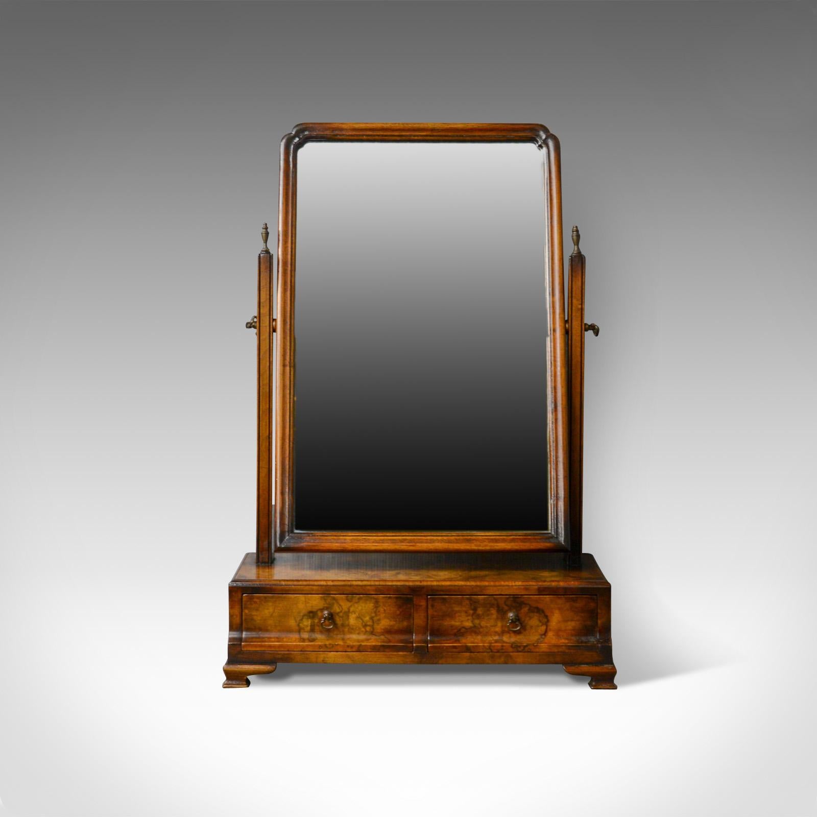 This is an antique dressing table mirror in burr walnut. An English, Georgian revival, vanity, toilet mirror dating to the early 19th century, circa 1910.

Mid-sized vanity mirror in the Georgian revival taste
Fine burr walnut finish displaying
