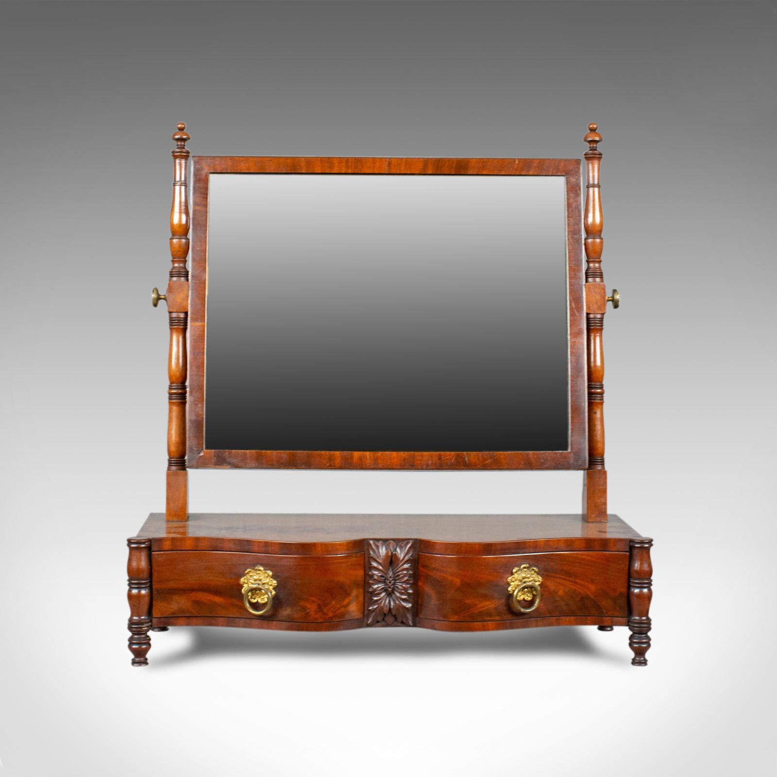 This is an antique dressing table mirror in flame mahogany. An English, Victorian, vanity, platform, toilet mirror dating to circa 1890.

A mid-sized, adjustable mirror in fine order throughout
Flame mahogany displaying grain interest and a