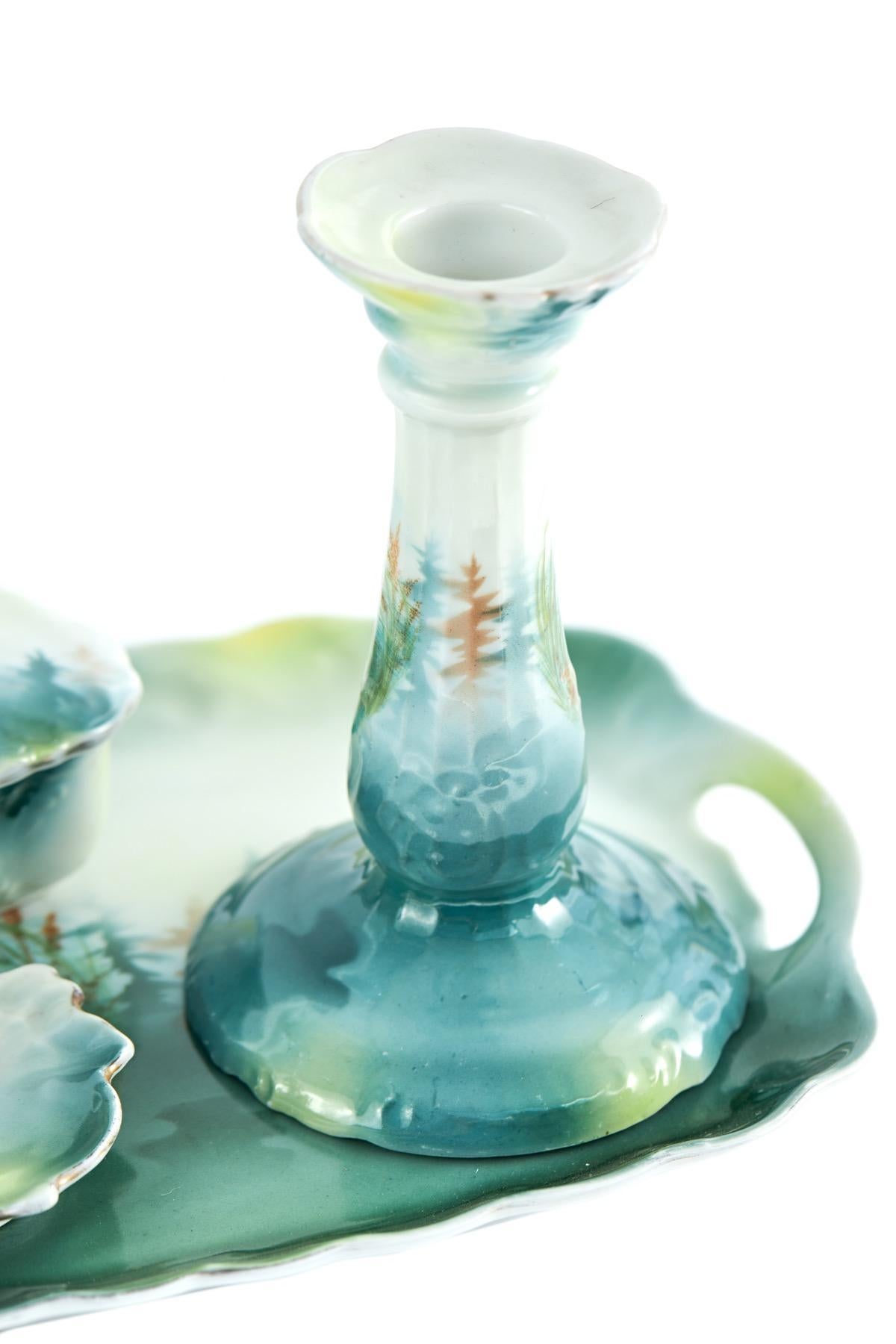 Antique dressing table set made of porcelain and decorated in lovely vibrant green colours and swans, carrying handles to the side of the tray, having 2 candlesticks, two lidded pots and dish.