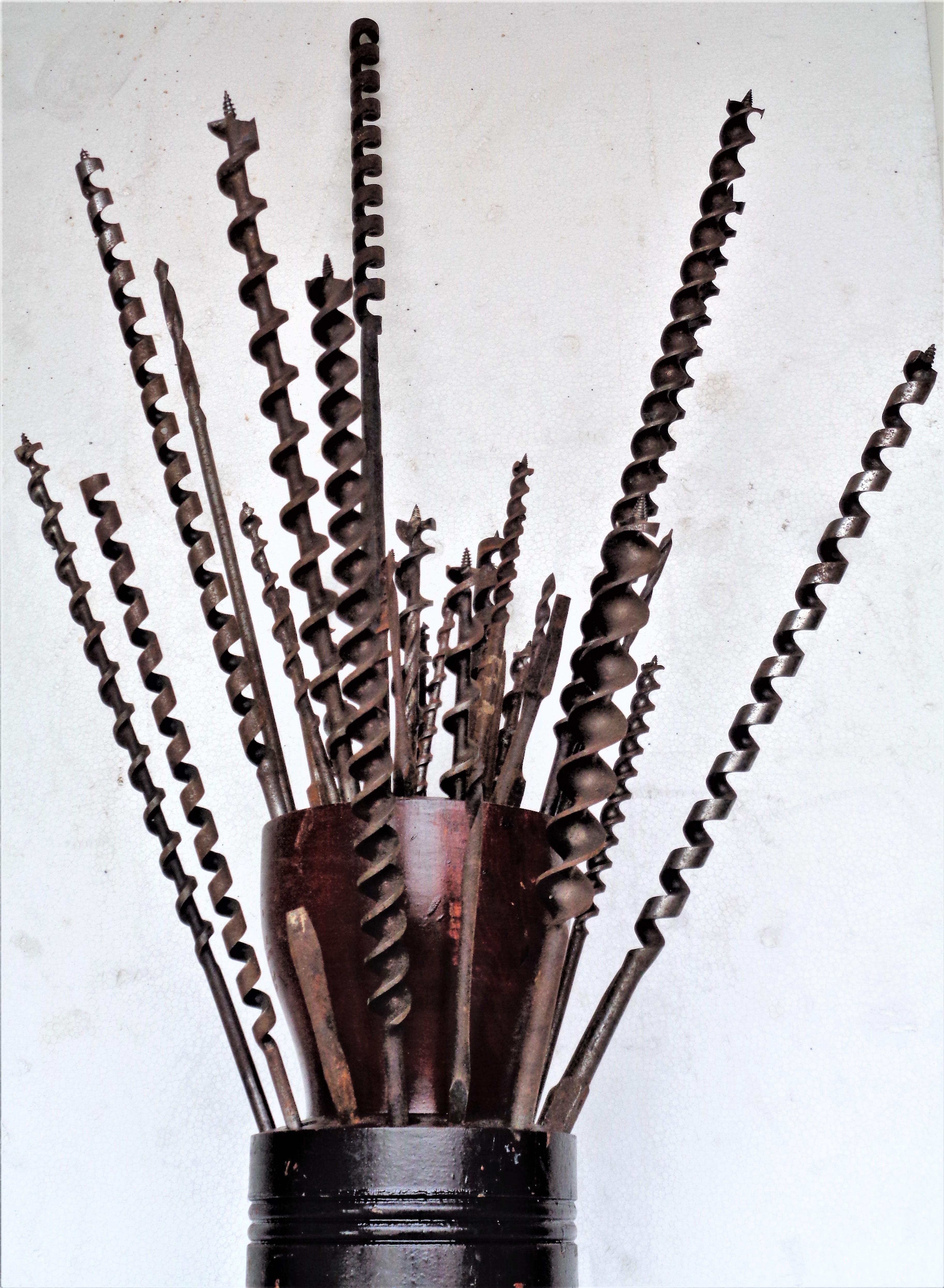 Antique industrial two tiered lathe turned wood drill bit holder with drill bits and augers. Drill bits are not fixed and can be arranged in different positions. Many of the drill bits are signed - some could be an uncommon or hard to find type, we