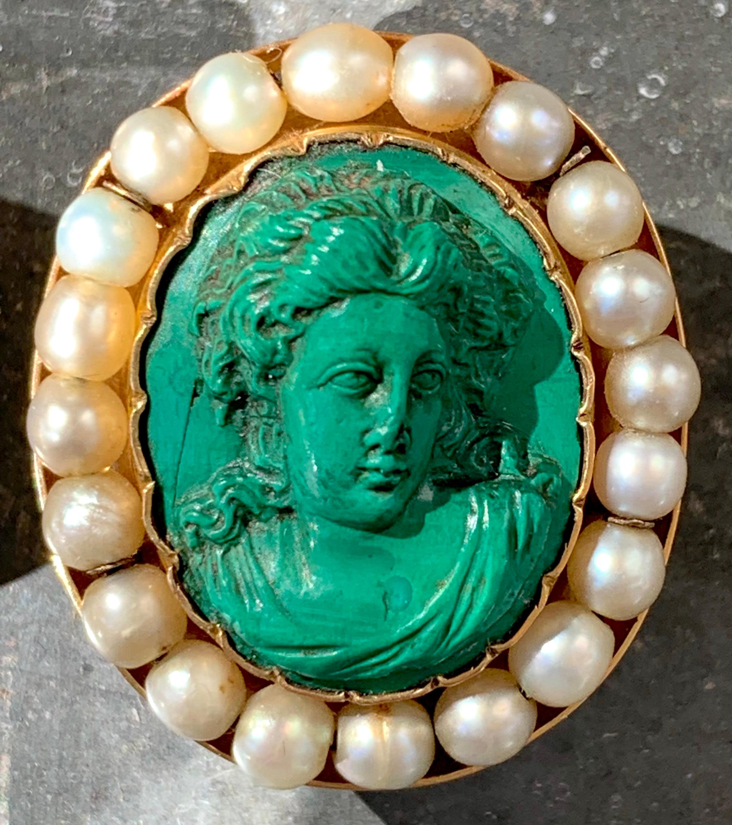 This stunning pair of earrings feature to fine malachite relief carvings portraying busts of young women in the Greek Revival taste. The cameos are mounted in wavy gold mounts within outer frames decorated with 20 fine oriental pearl beads each. The