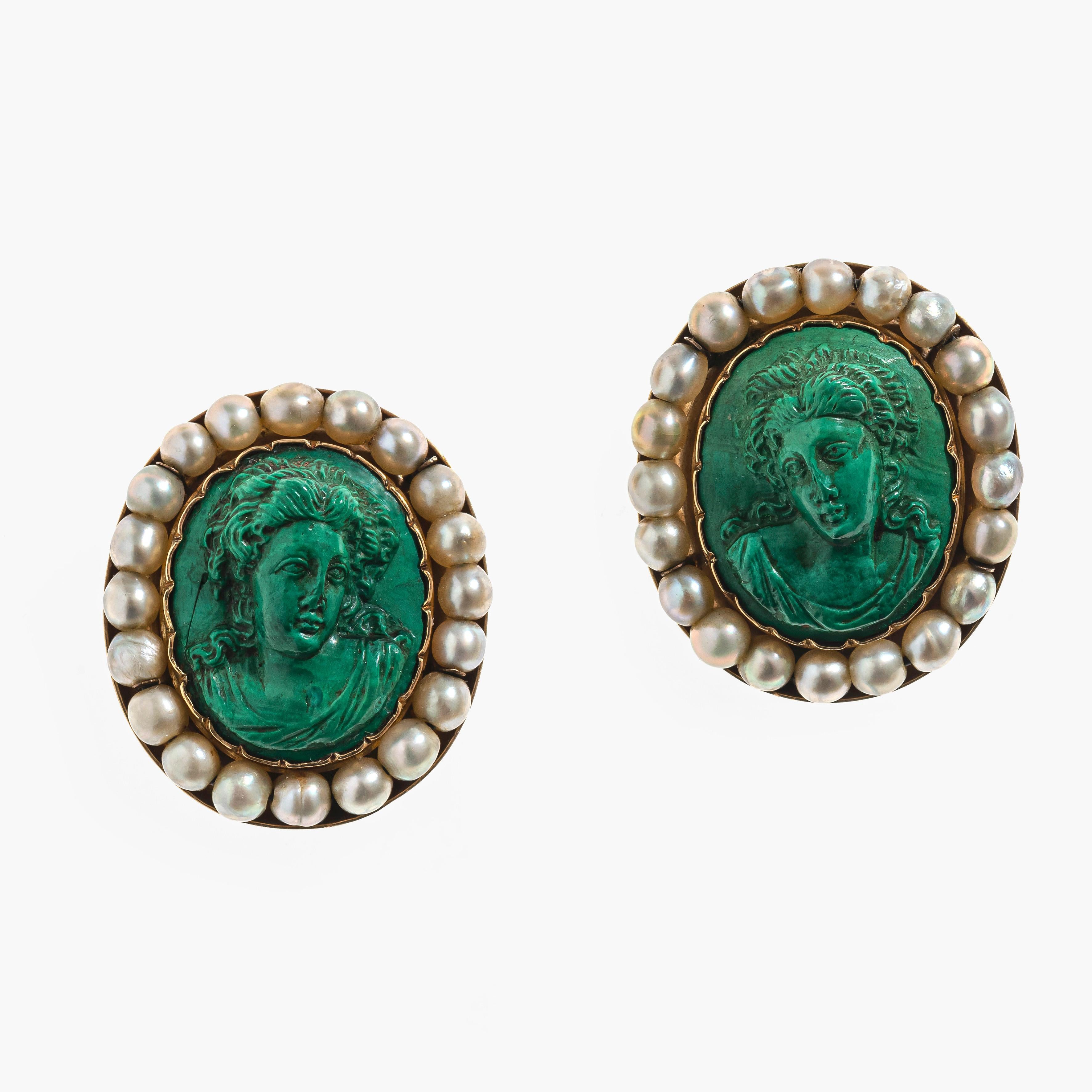 This stunning pair of earrings feature to fine malachite relief carvings portraying busts of young women in the Greek Revival taste. The cameos are mounted in wavy gold mounts within outer frames decorated with 20 fine oriental pearl beads each. The