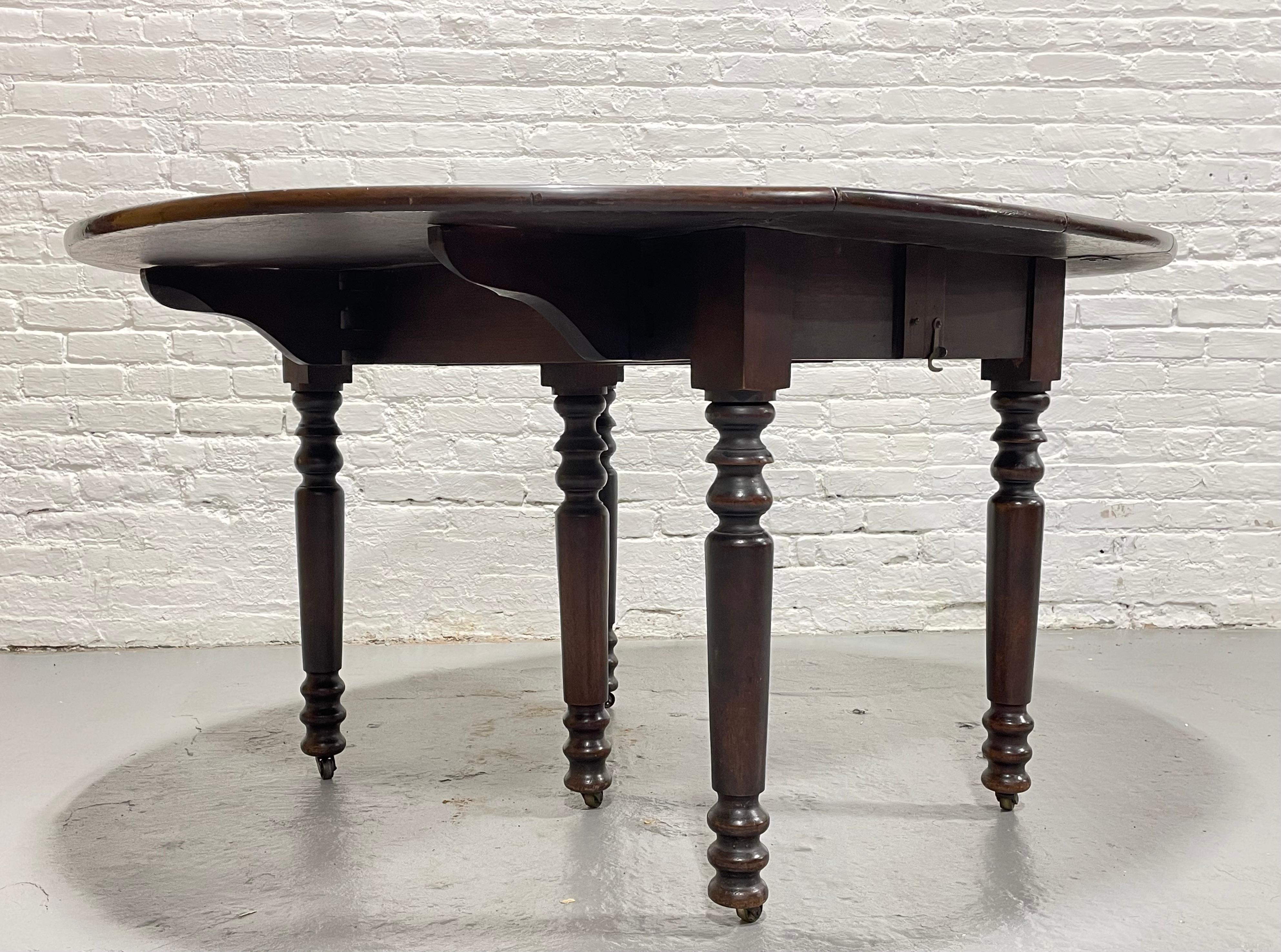Turned Antique Drop Leaf Expandable Mahogany Oval Dining Table, c. 1910 For Sale
