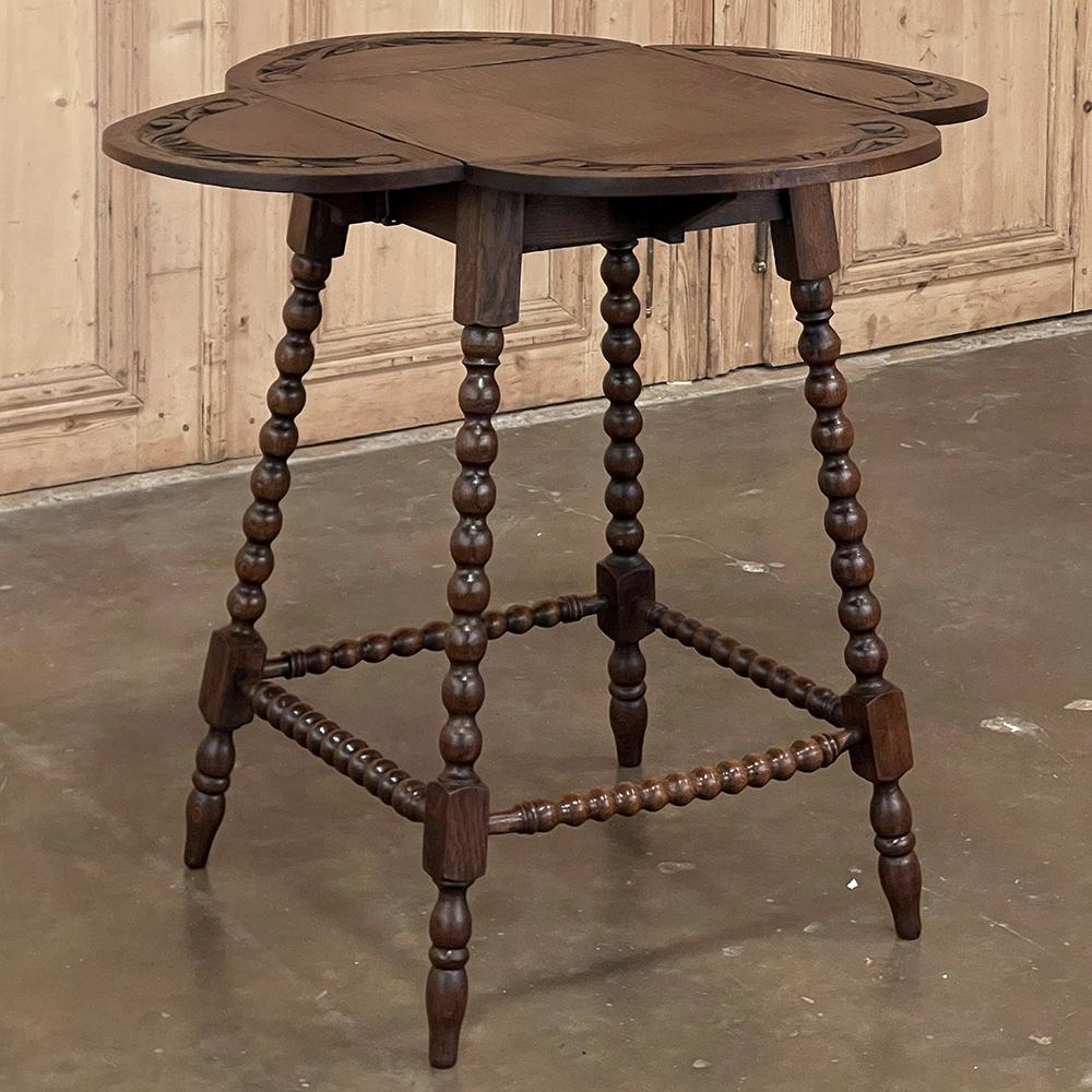 Antique drop leaf spool leg end table is a marvel of design and craftsmanship on a wonderfully diminutive scale! Four spooled legs are splayed for extra stability and connected below with stretchers and tipped with turned teardrop-shaped feet, and