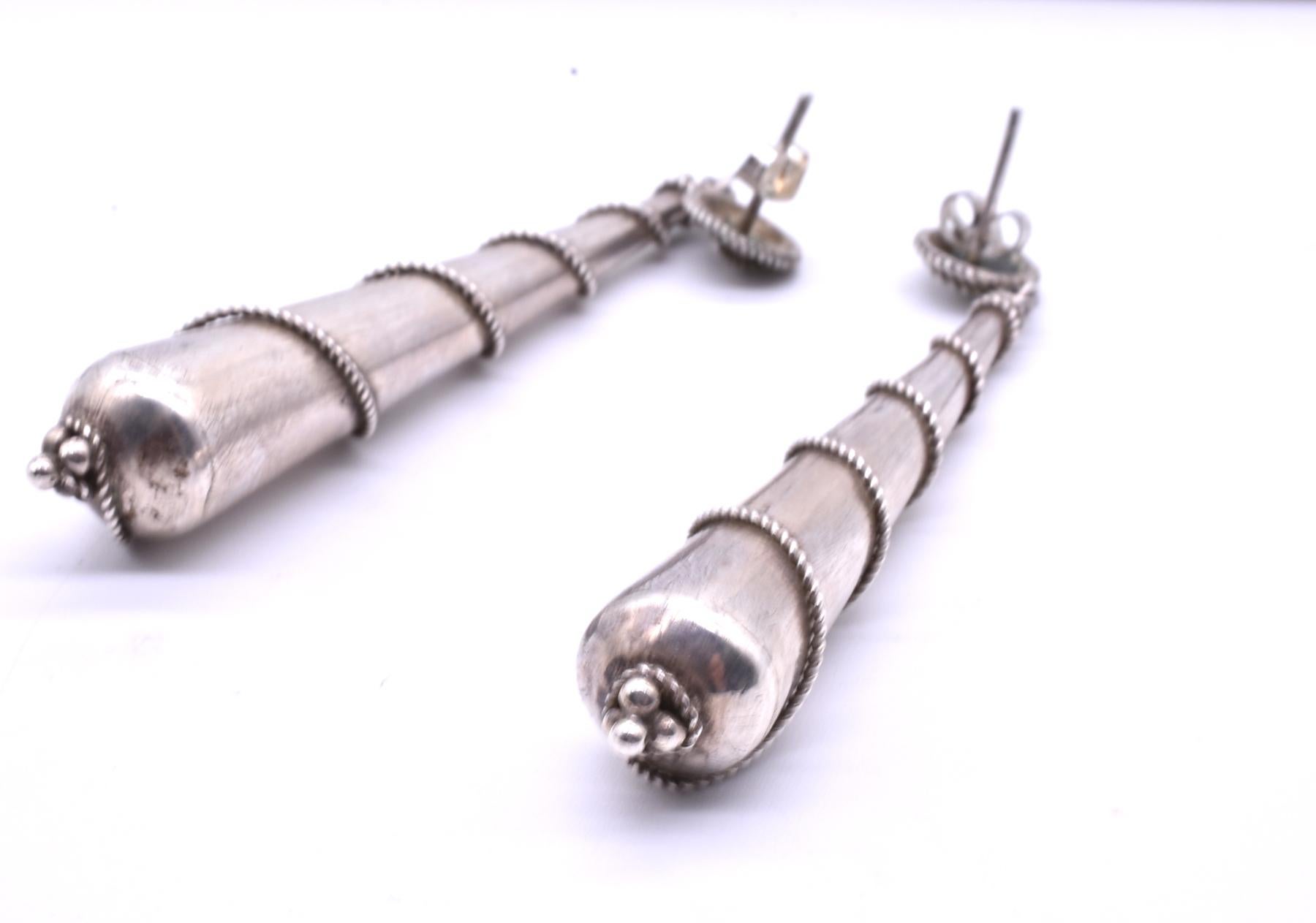 C1860 sterling silver pendeloque earrings,  over three inches long, make a statement no matter the occasion. The silver earrings have a thin fluted silver band wrapped round and round culminating in a small finial at the bottom. The thin silver