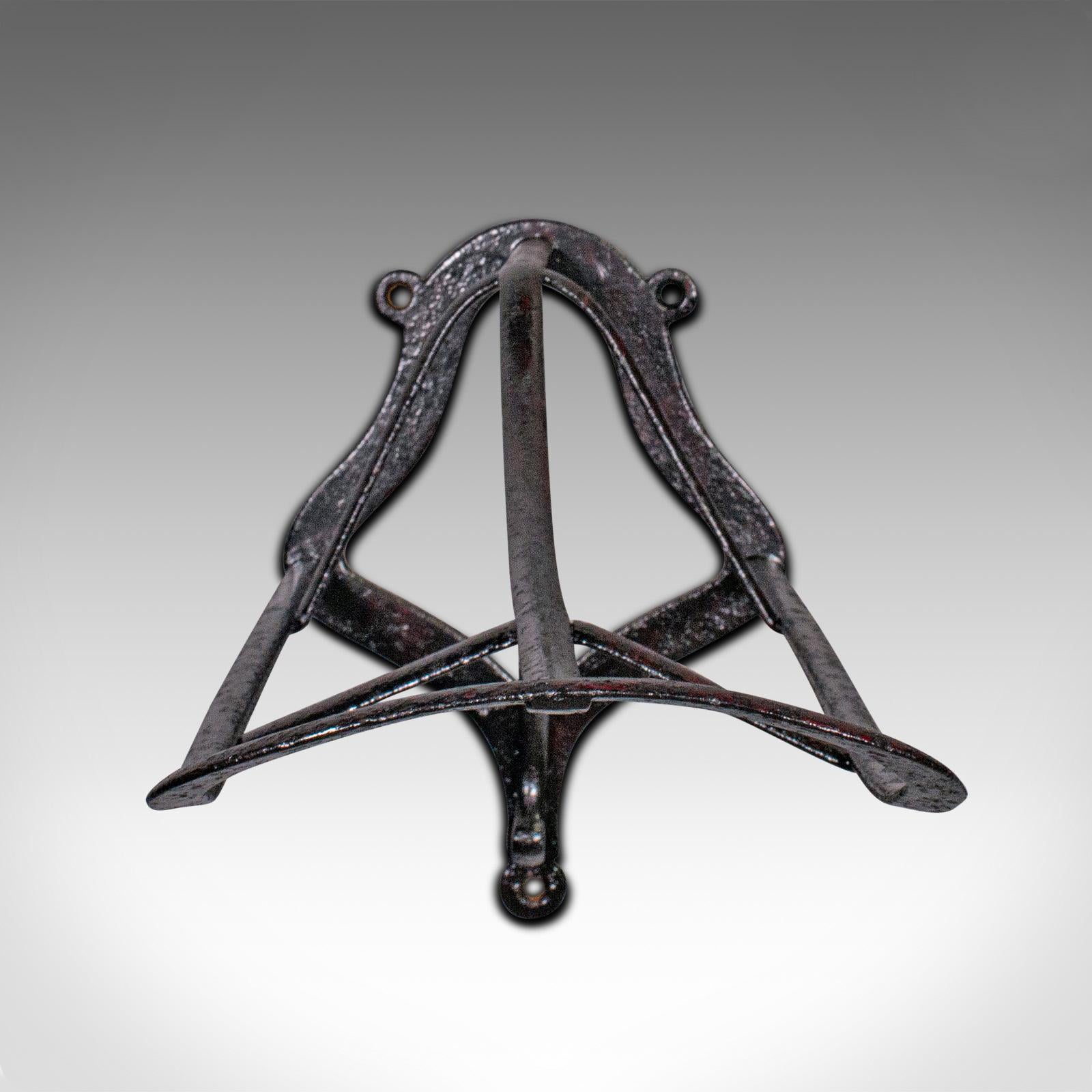 This is an antique 'duck bill' saddle rack. An English, cast iron wall mounted equestrian tack rest, dating to the early Victorian period, circa 1890.

Classically appealing saddle rack as useful today as it was nearly 150 years ago
Displays a