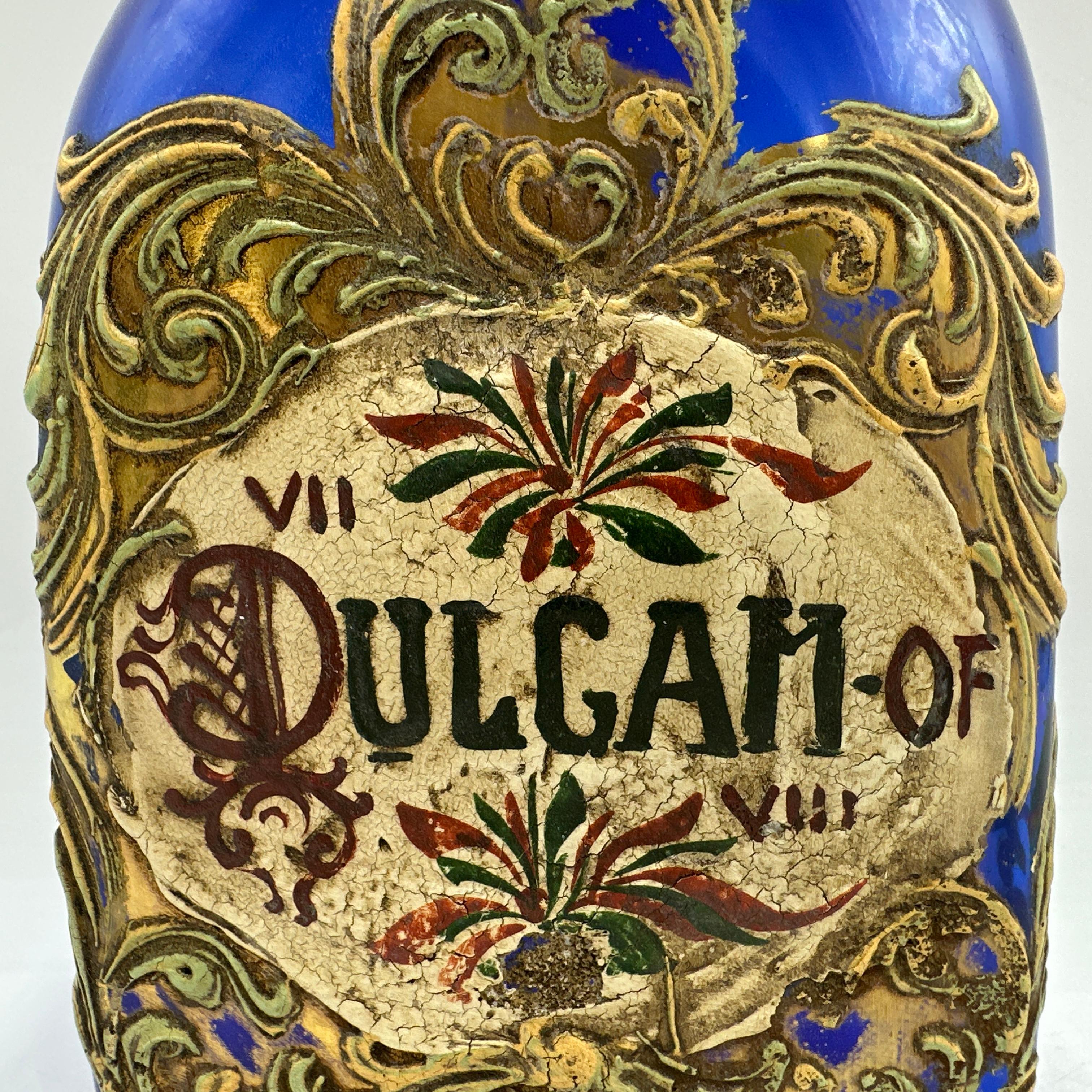 Here is a beautiful Antique Italian Murano Glass Pharmacy Apothecary Jar. Elaborately hand painted and gilt on cobalt blue Murano glass. Featuring an orange with leaf on the lid. Reads “DULCAM”. 

Overall good condition with no chips or cracks. Some
