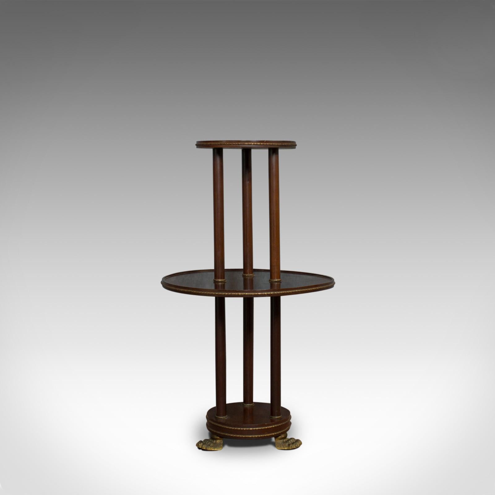 This is an antique dumb waiter. An English, Victorian, mahogany tiered table displaying Empire styling and dating to the late 19th century, circa 1880.

Rich mahogany in russet hues display a desirable aged patina
Detailed gilt metal banding in