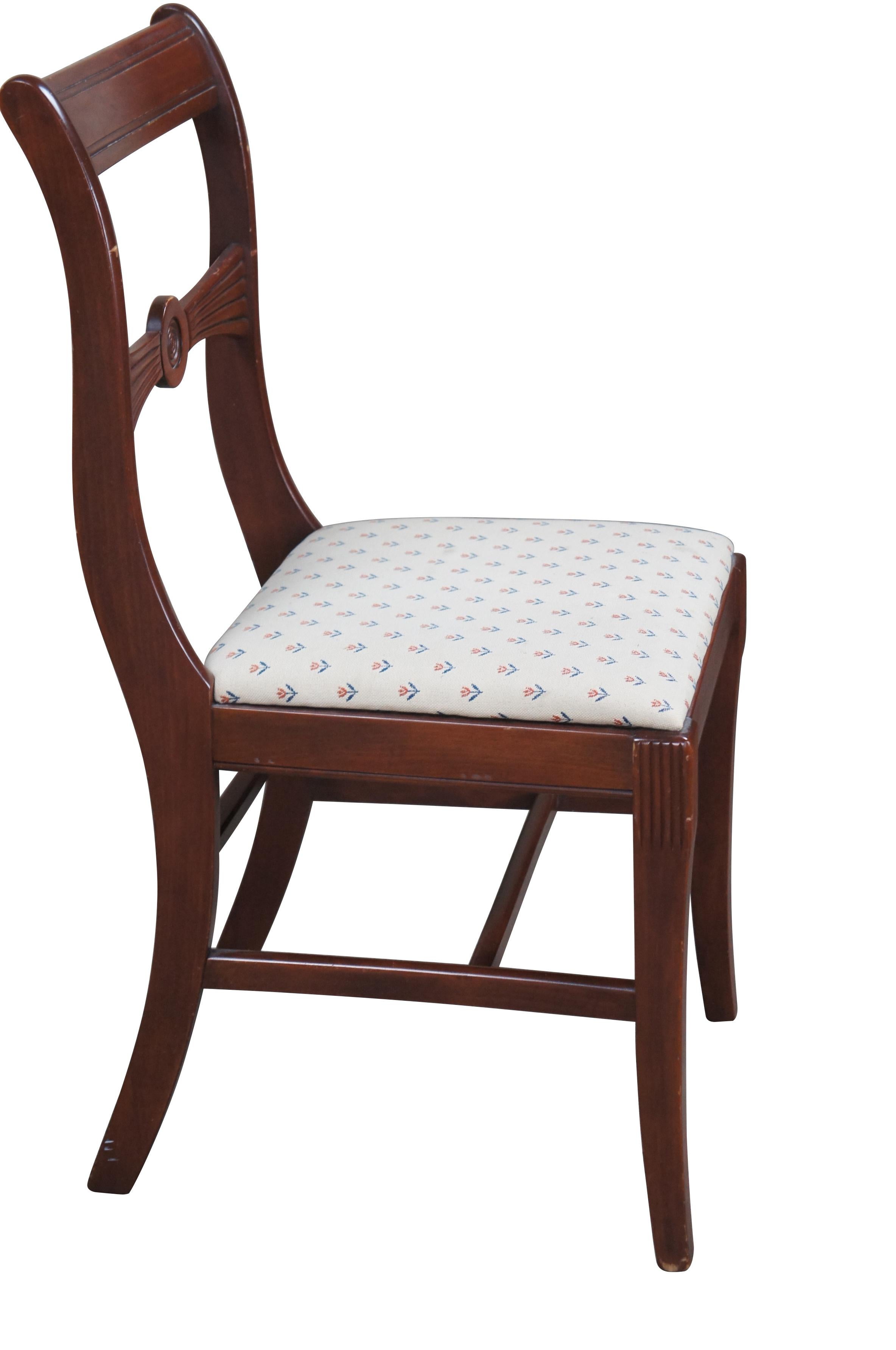 1940s Duncan Phyfe / Regency Style dining side chair.  Made from mahogany with a contoured crest rail and bow shaped back.  Features an upholstered seat with repeating tulip / rose pattern.  Front legs are fluted along the front corner and tapered,