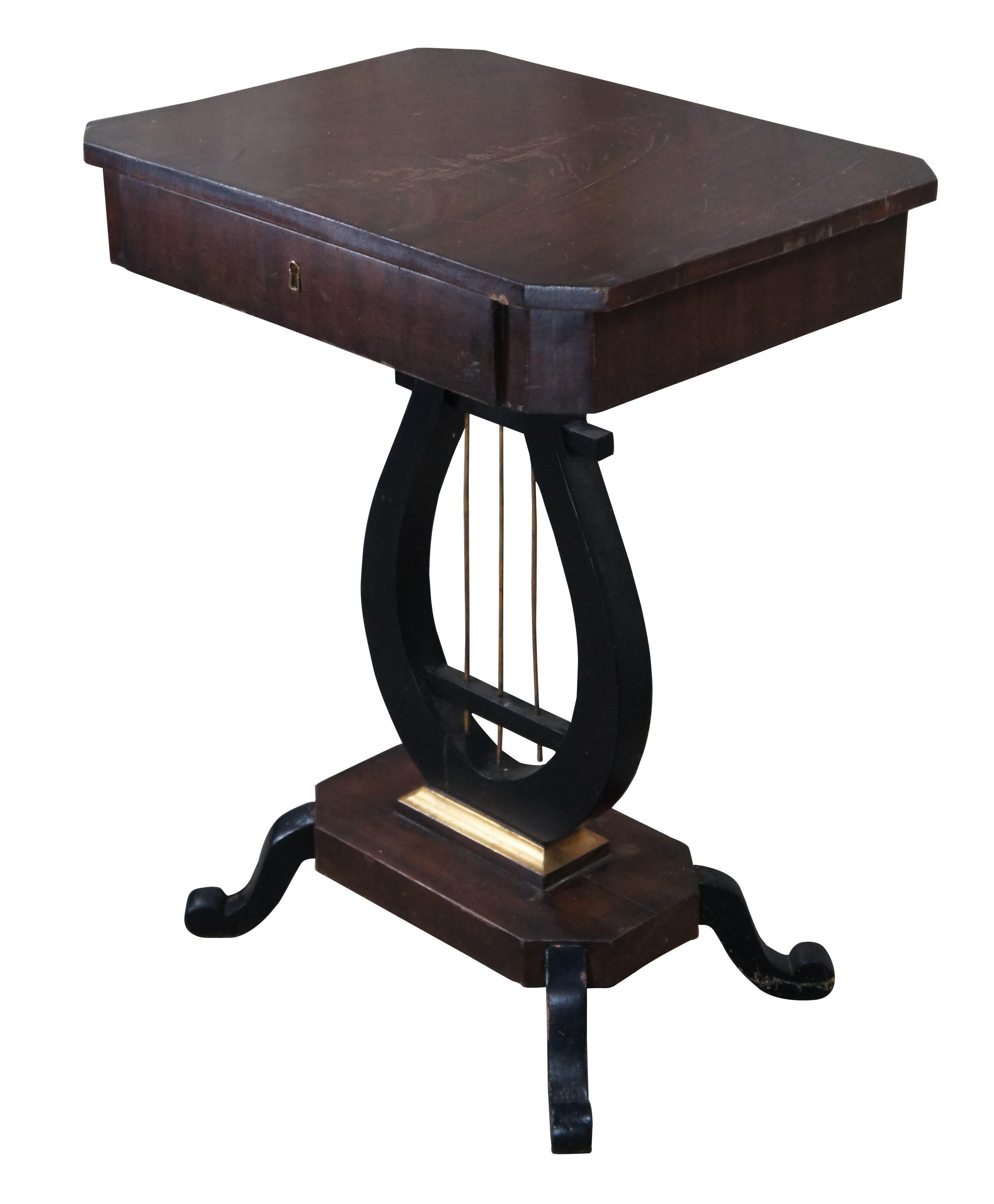 Early 20th Century Duncan Phyfe Style Occasional Sewing or Spool Table.  Features a crotch mahogany frame over an ebonized lyre base with brass rods and downswept scrolled feet.  Includes a divided pine dovetailed drawer.  

Dimensions:
22