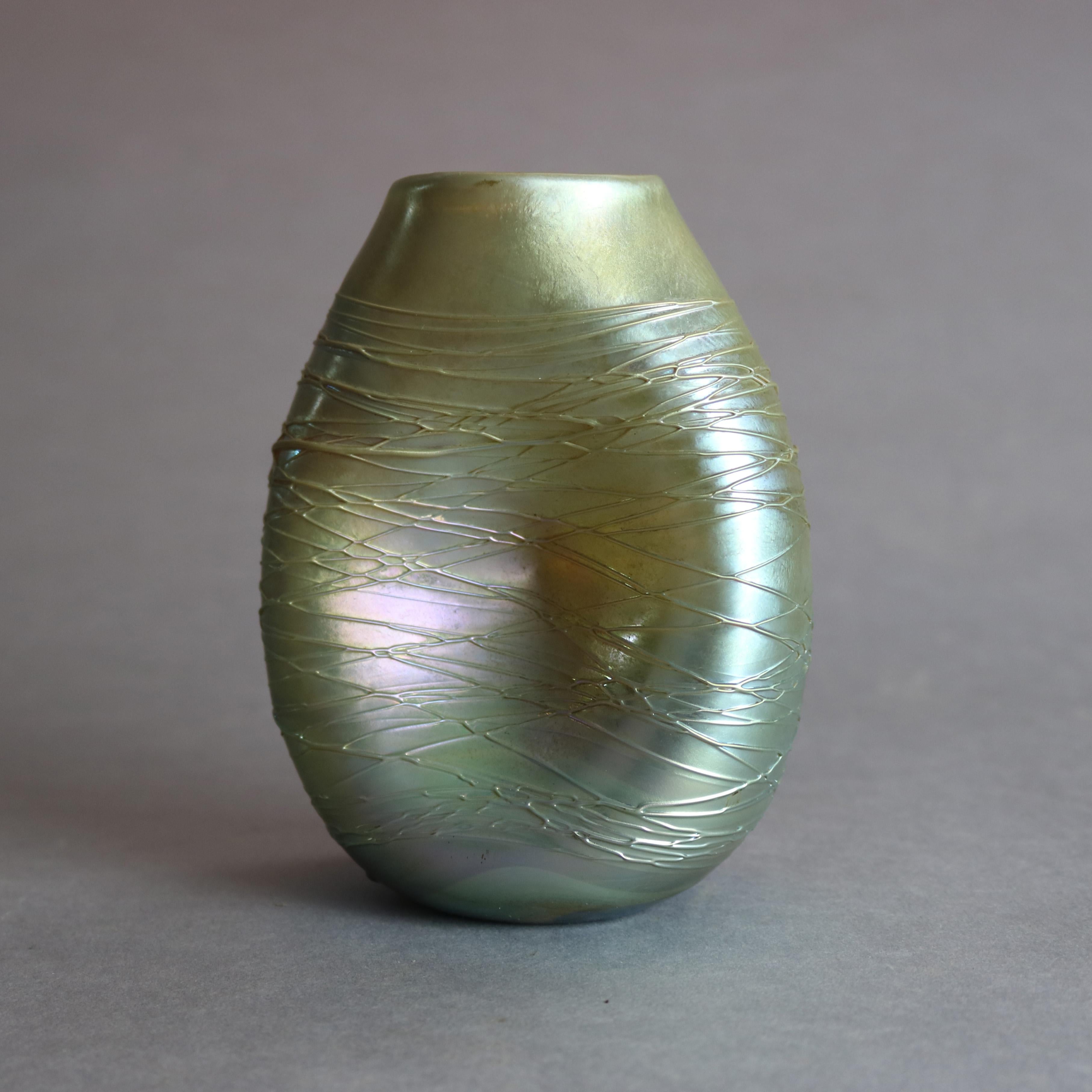 An antique art glass vase by Durand features threaded glass in pinched form, signed on base 