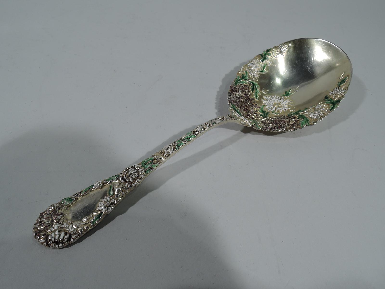 Antique Japonesque gilt sterling silver and enamel berry spoon in Chrysanthemum pattern. Made by Durgin in Concord, New Hampshire. Tapering handle with round terminal and oval bowl. Raised double-sided ornament comprising dense flower heads and