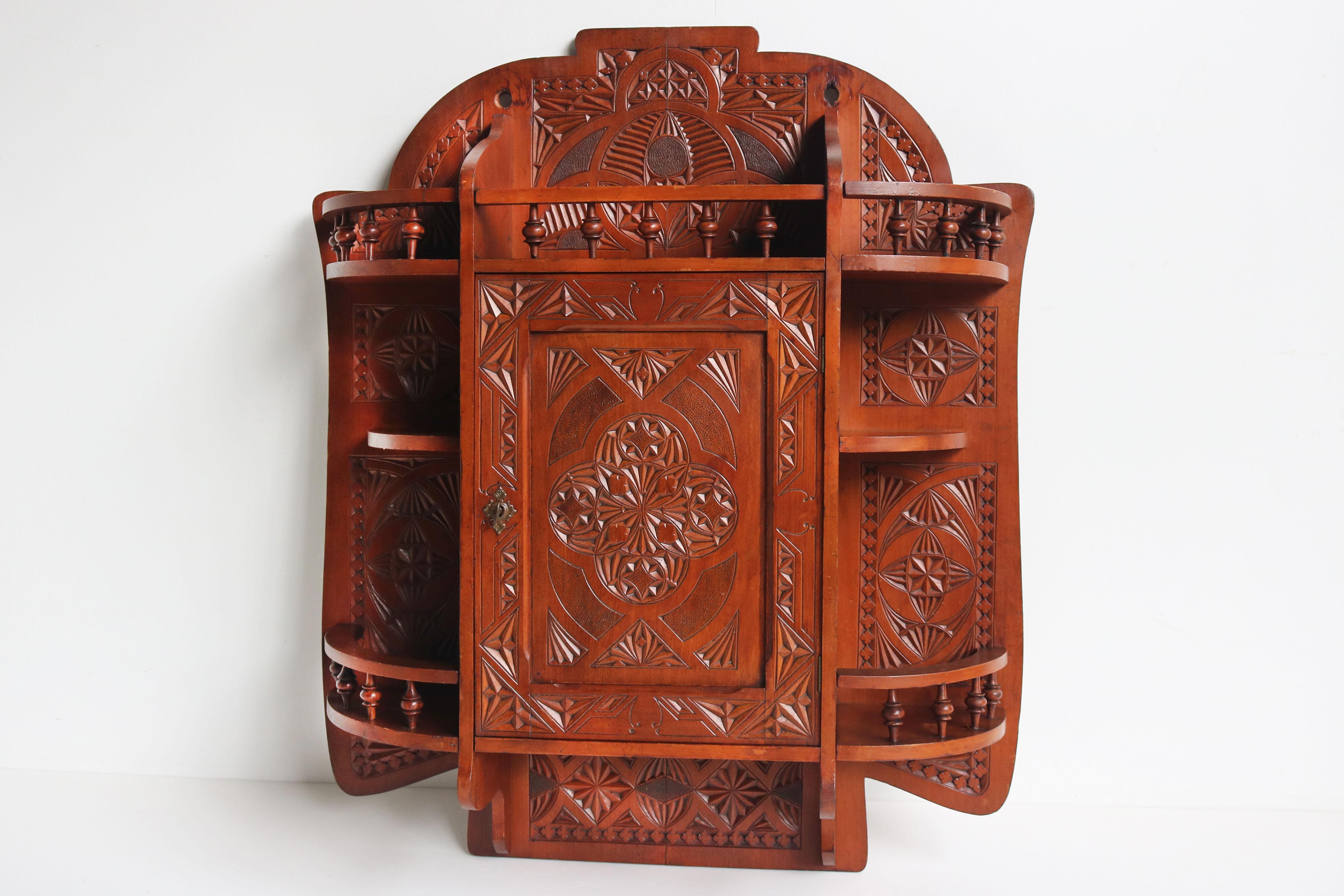 Introducing this stunning chip carved wall cabinet! Handcrafted with a traditional Dutch chip carving technique, this beautiful piece adds warmth and charm to any room. The intricate design and detail make it a true statement piece that catches the