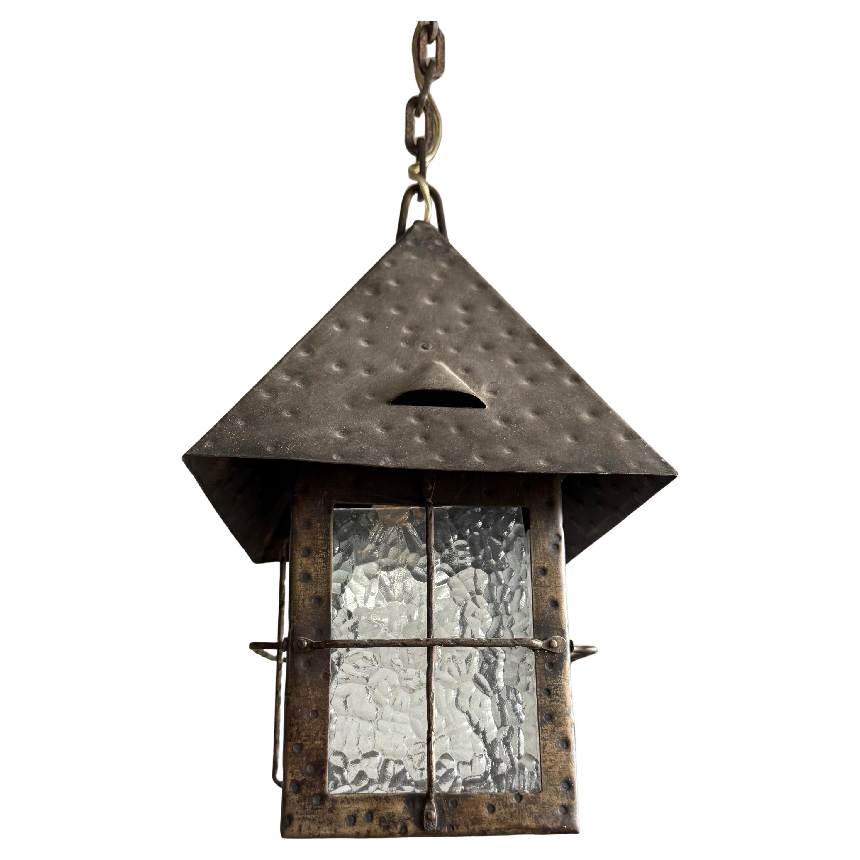 One of a kind, hand-crafted pendant with original glass.

A fine and authentic Arts & Crafts ceiling pendant, hand-crafted in wrought iron around 1910 in the Netherlands. Originally created for the entrance of an Arts and Crafts house, this lantern