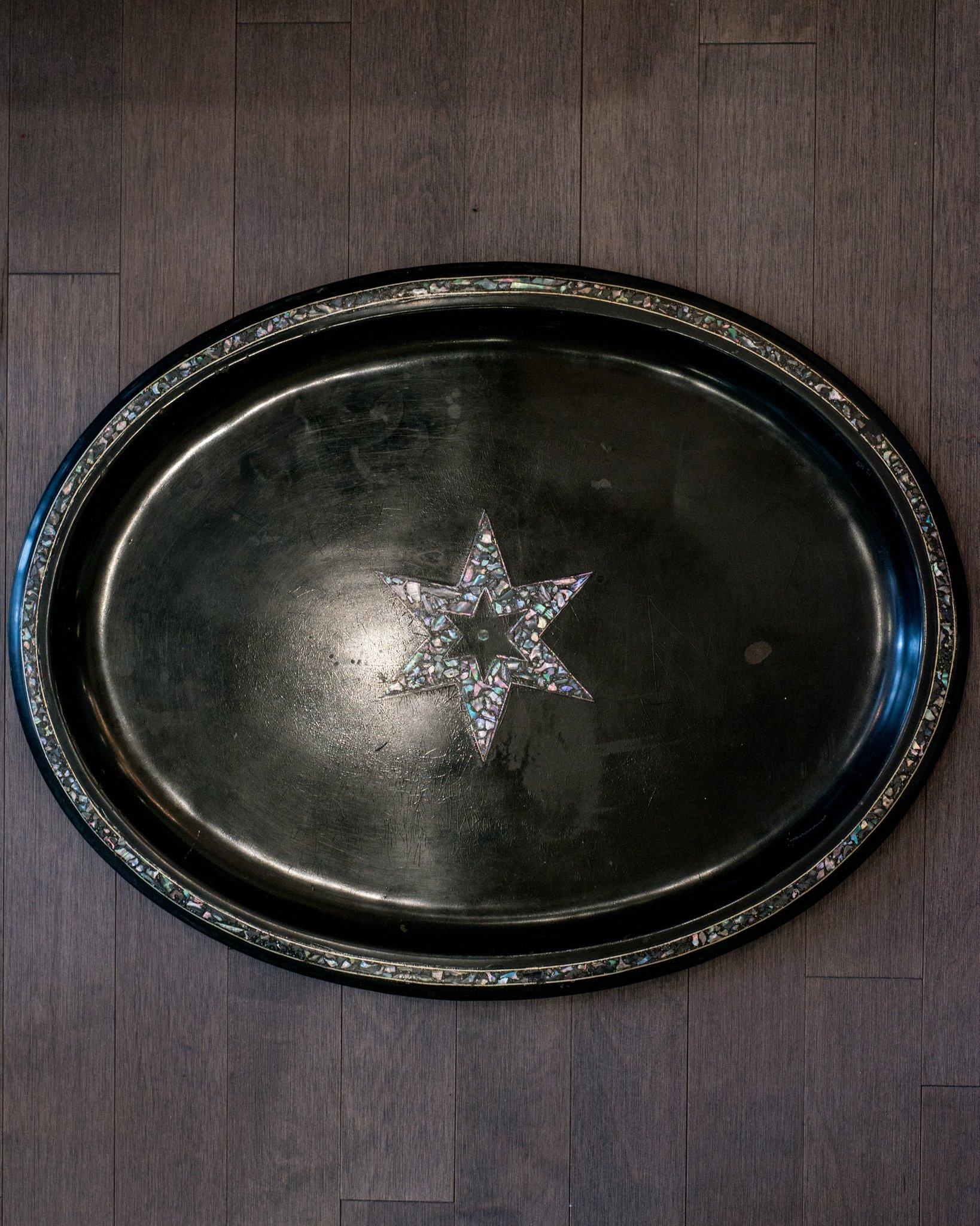 This unique antique Dutch metal tray with mother of pearl inlaid star motif was sourced on a trip to Holland.