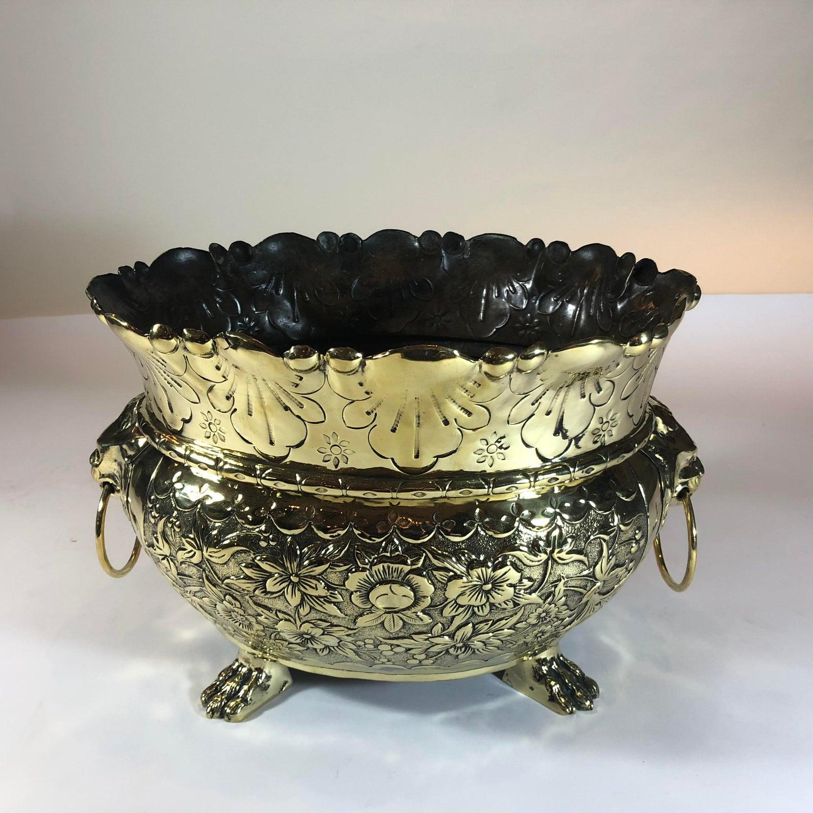 The repousse work is very nice with its footed base, and this jardiniere is medium in size.
 