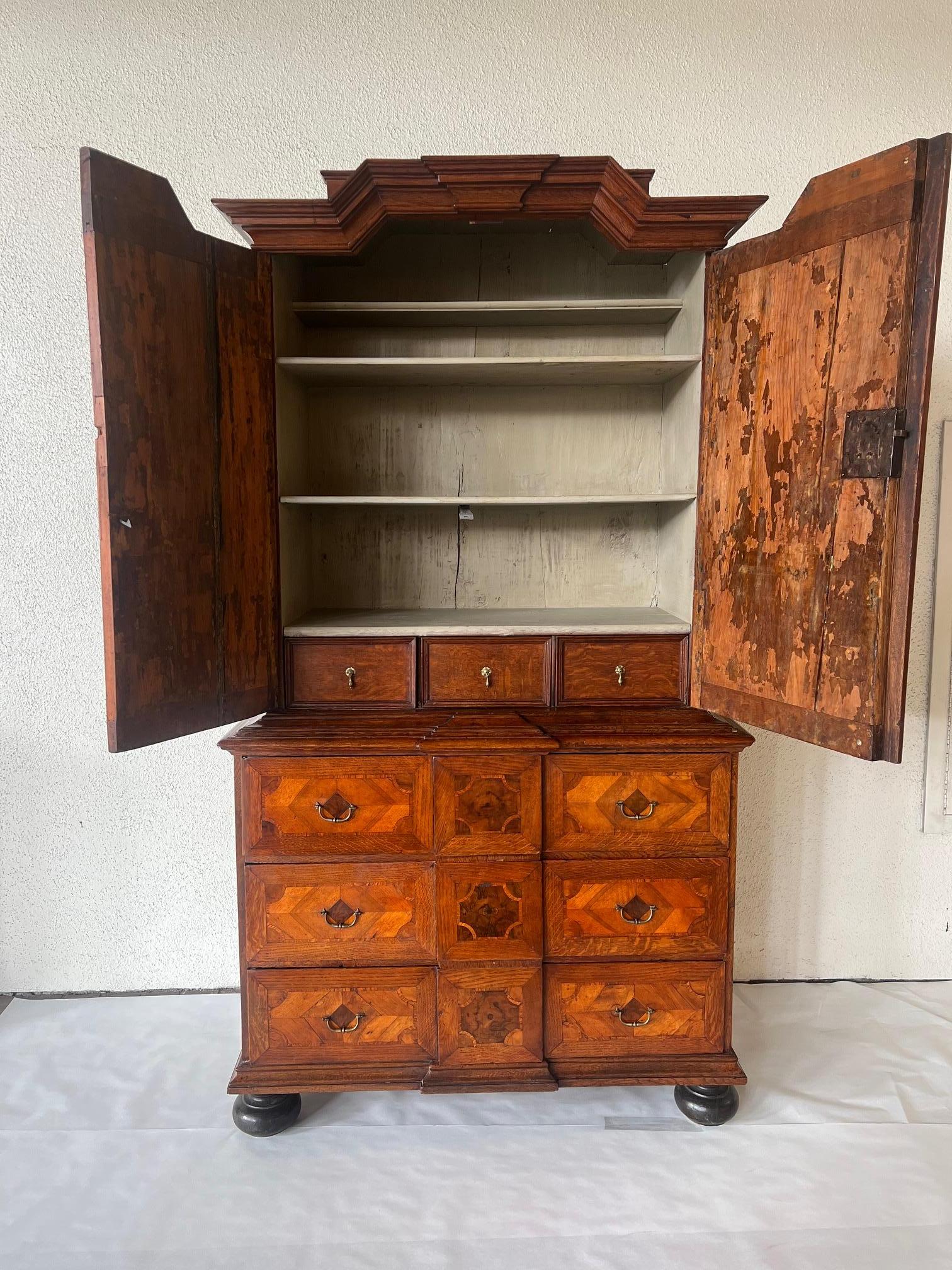 Two piece antique Dutch cabinet crafted from walnut and mahogany and newly restored. This three drawer chest offers up plenty of storage while also serving up style. Painted inside with shelving.