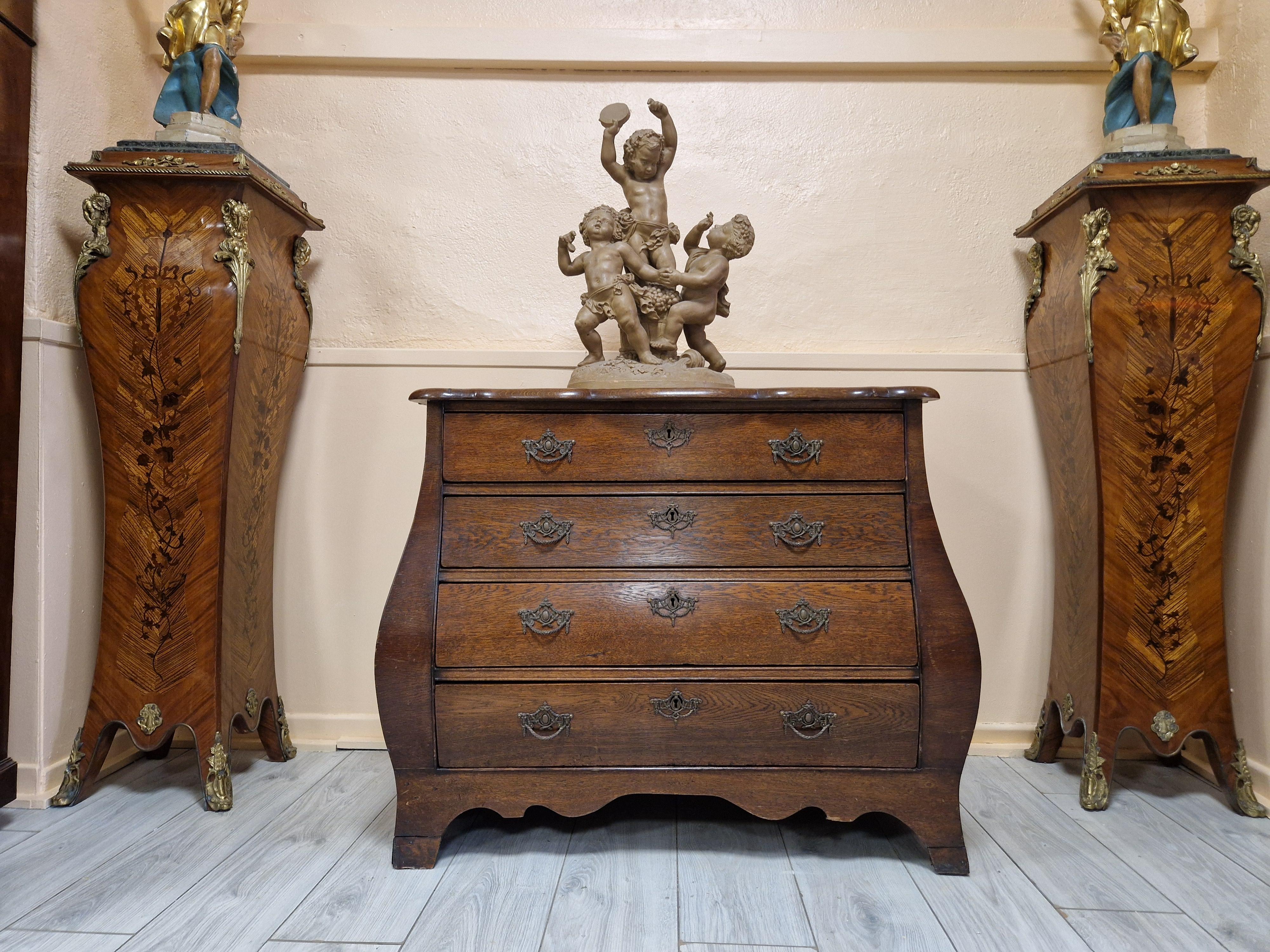 Crafted in the Netherlands during the Victorian era, this Antique Dutch Chest of Drawers offers a timeless charm that effortlessly complements any room. Its rich brown wood finish, coupled with the distinctive shape, exemplifies the classic