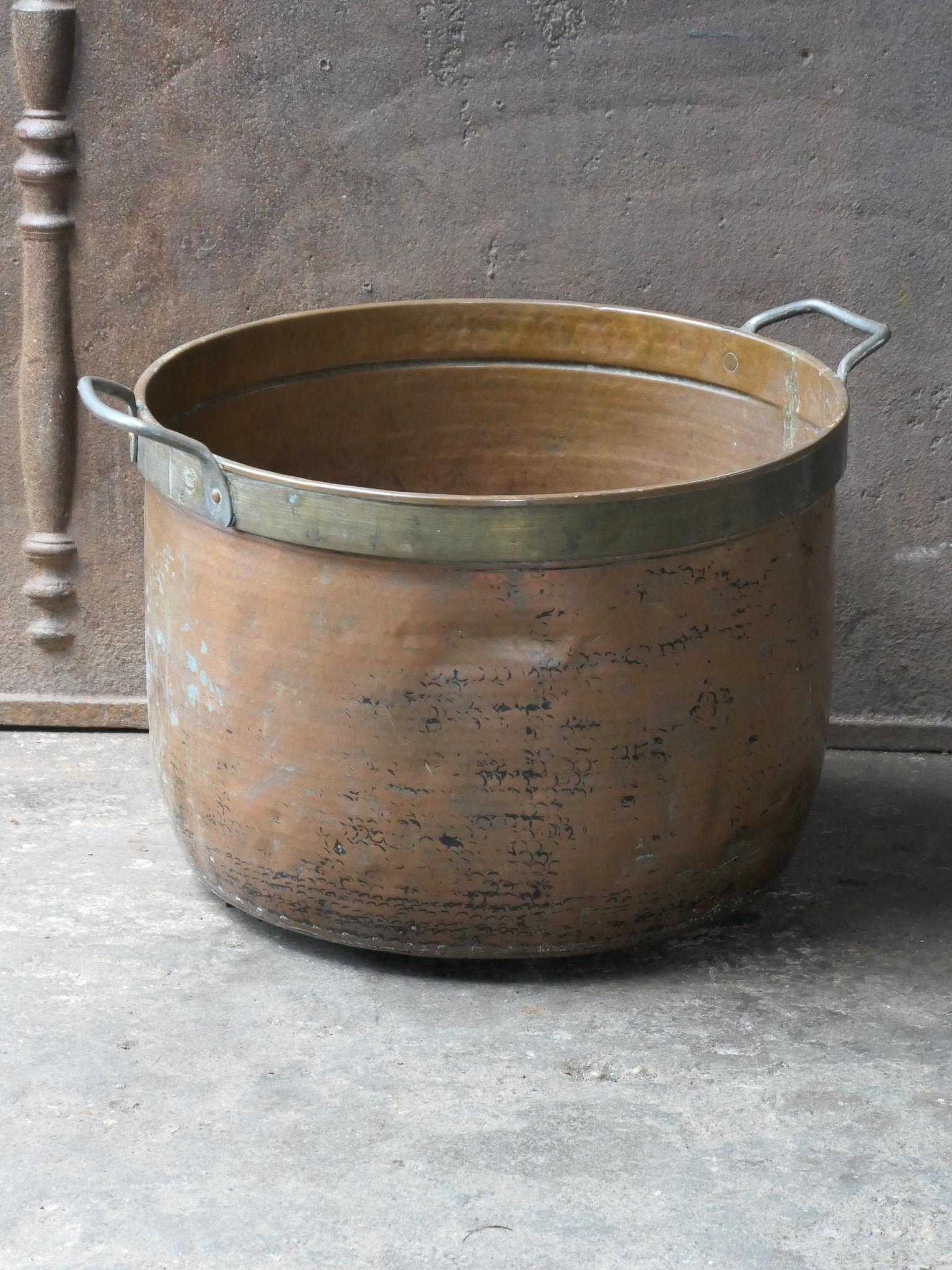 18th - 19th Century Dutch neoclassical log basket. The firewood basket is made of  copper and brass with wrought iron handles. Also called 'aker'. Used to draw water from the well and cook over an open fire.

The log holder is in a good condition