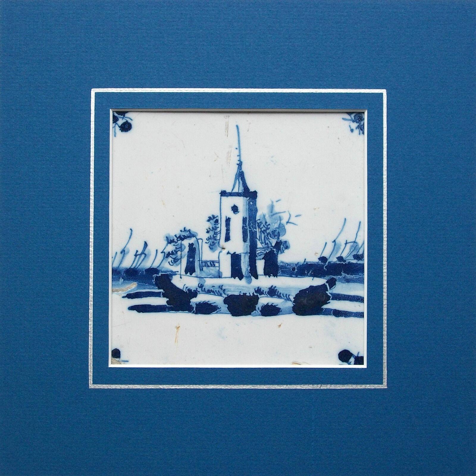 Antique Dutch delft ceramic tile - hand crafted - hand painted cobalt blue glaze - unsigned - Holland / Netherlands - 17th century.

Contained in a professional contemporary metal frame - surrounded by a blue matte board with bevel edge and hand
