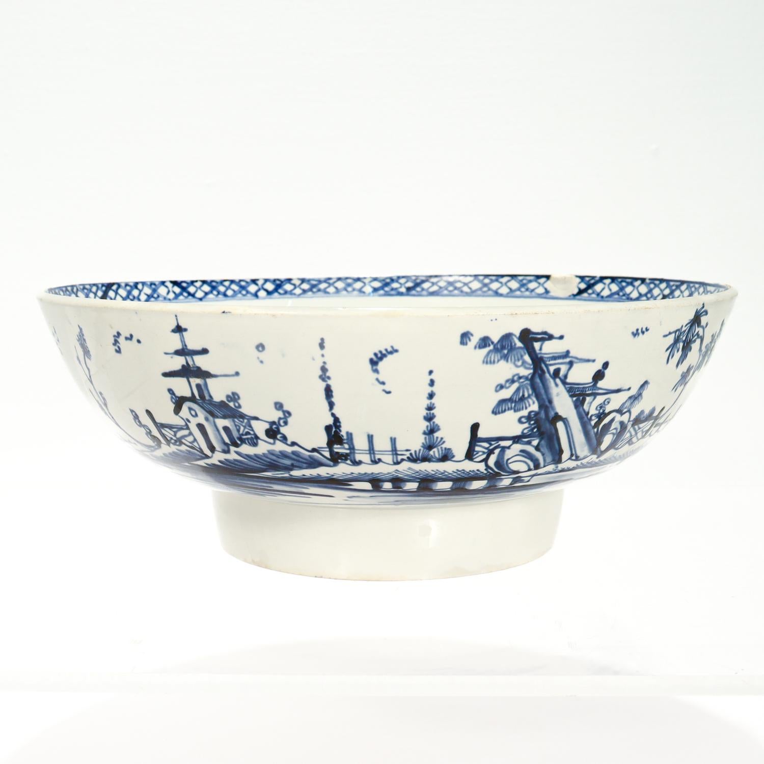 A fine antique Dutch Delft bowl.

With landscape scenes to the center and exterior of the bowl, and a geometric border to the rim.

With an old note to the bottom that reads: 