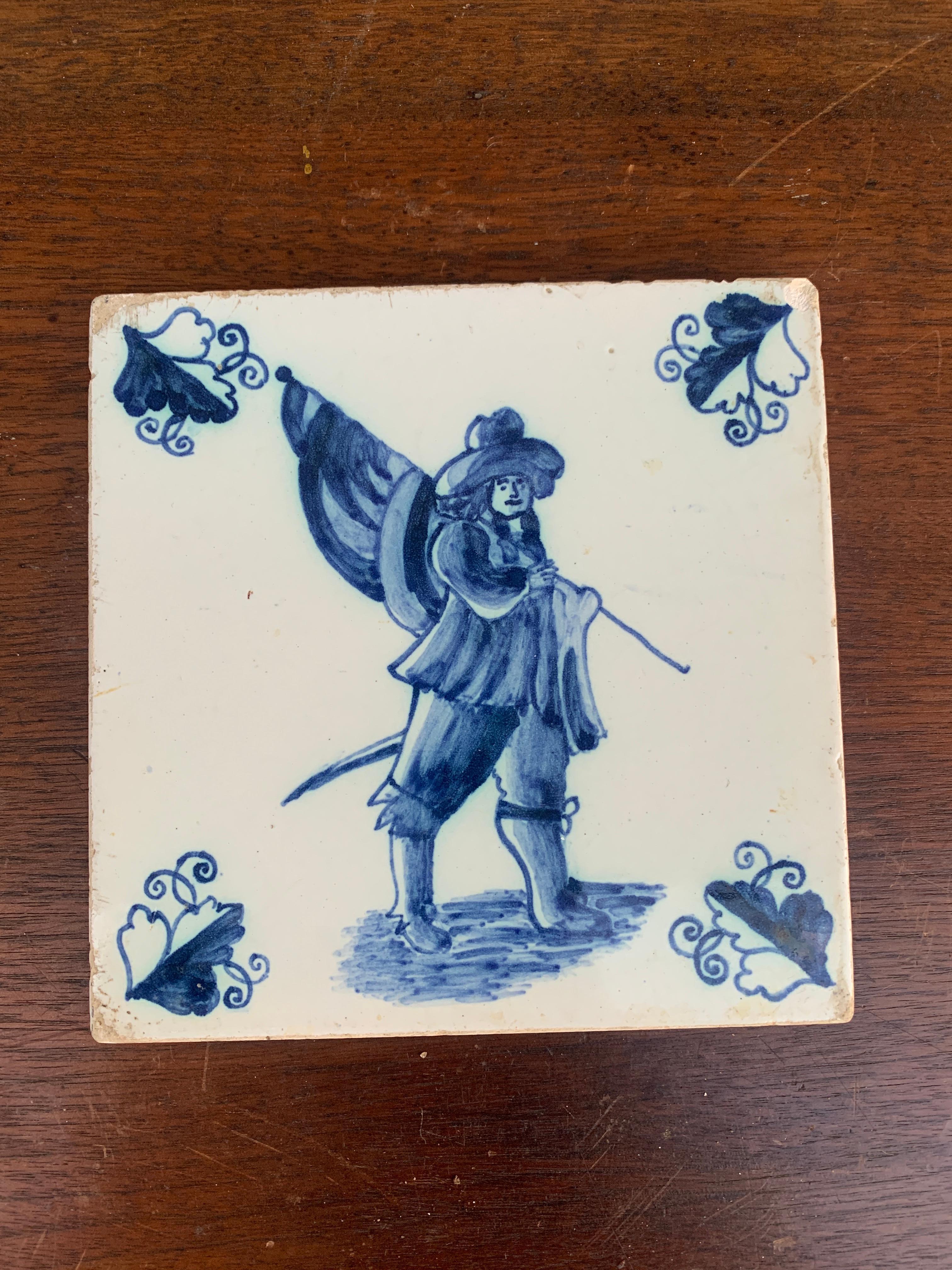 A beautiful antique hand painted blue and white Delft or French Provincial style ceramic tile featuring a soldier carrying a flag. This would make an excellent coaster.

Holland, Circa Mid-19th Century

Measures: 5.25