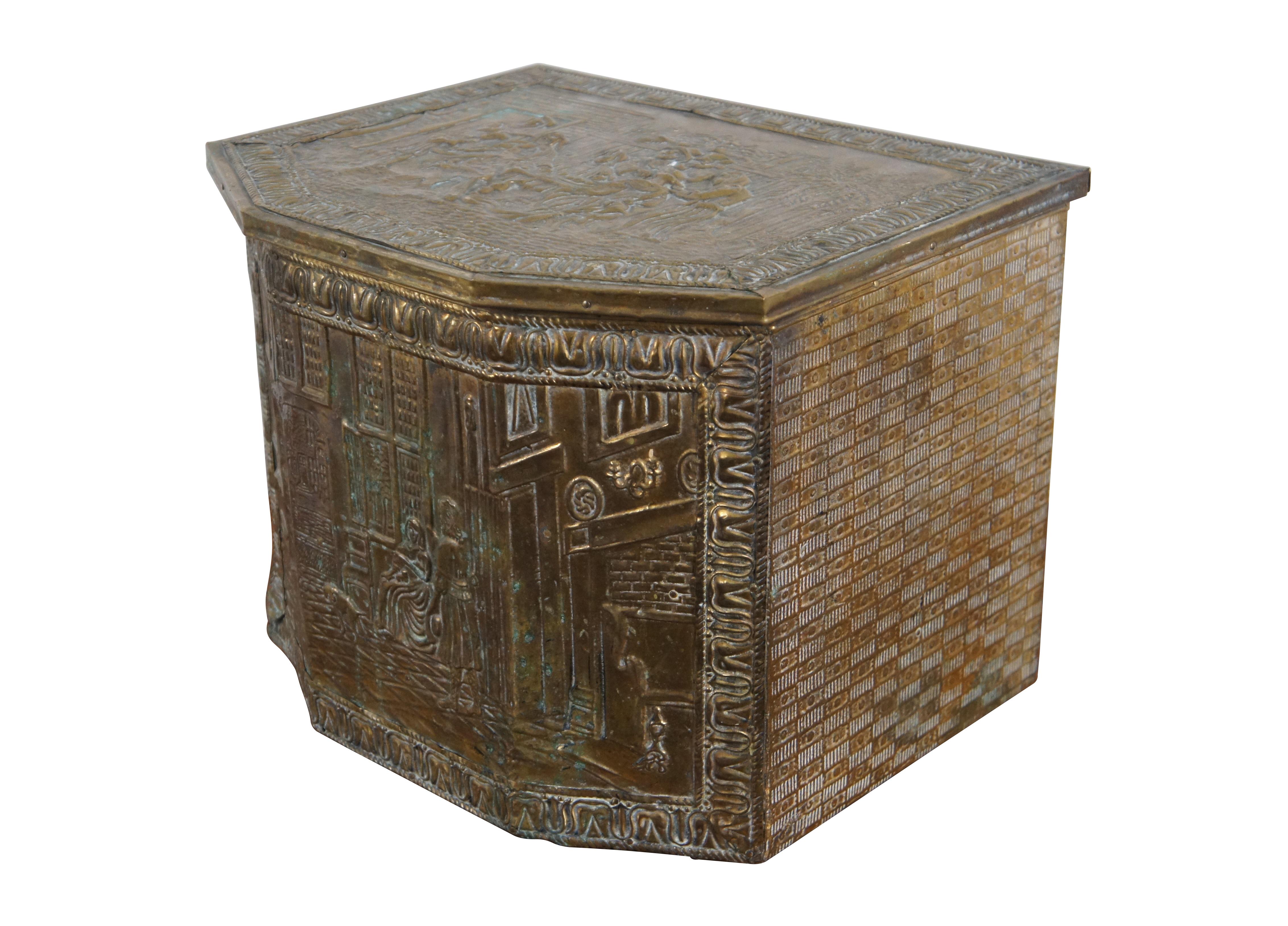 Antique Dutch fireside coal / tinder box / bin / scuttle, made of hardwood and clad in brass, embossed with a textured checkered motif on the sides and manor scene on the front and a tavern scene on the lid, framed in a border of tulips. Includes