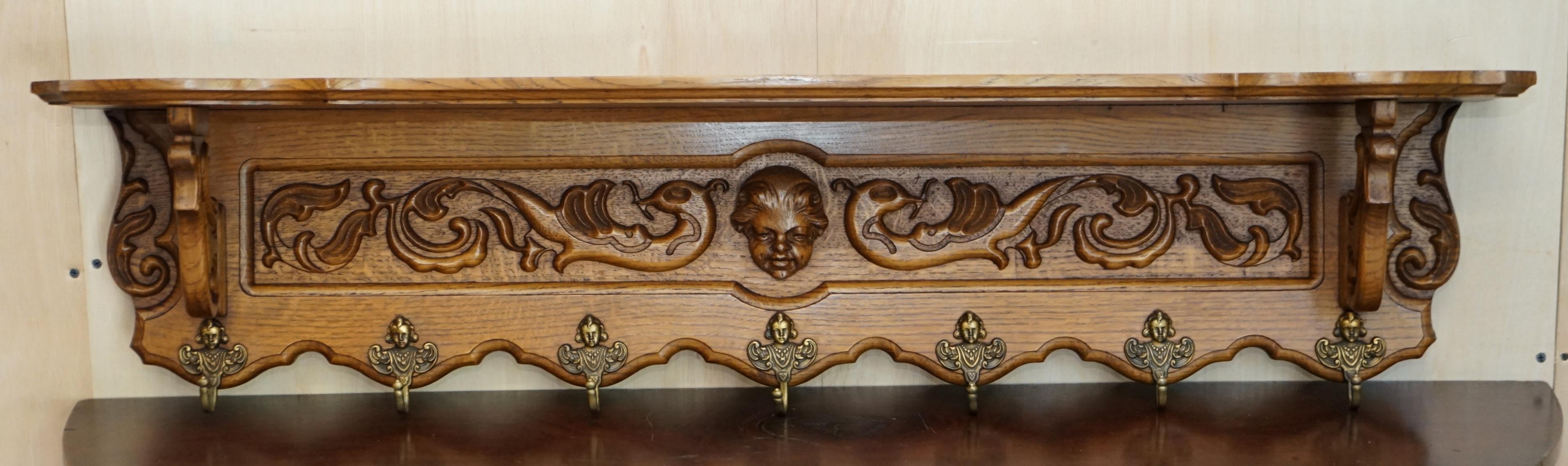 Royal House Antiques

Royal House Antiques is delighted to offer for sale this lovely, heavily carved Dutch oak wall hanging coat hat and scarf rack with French Royalty head gold gilt brass hooks and large Cherub head carved to the central middle