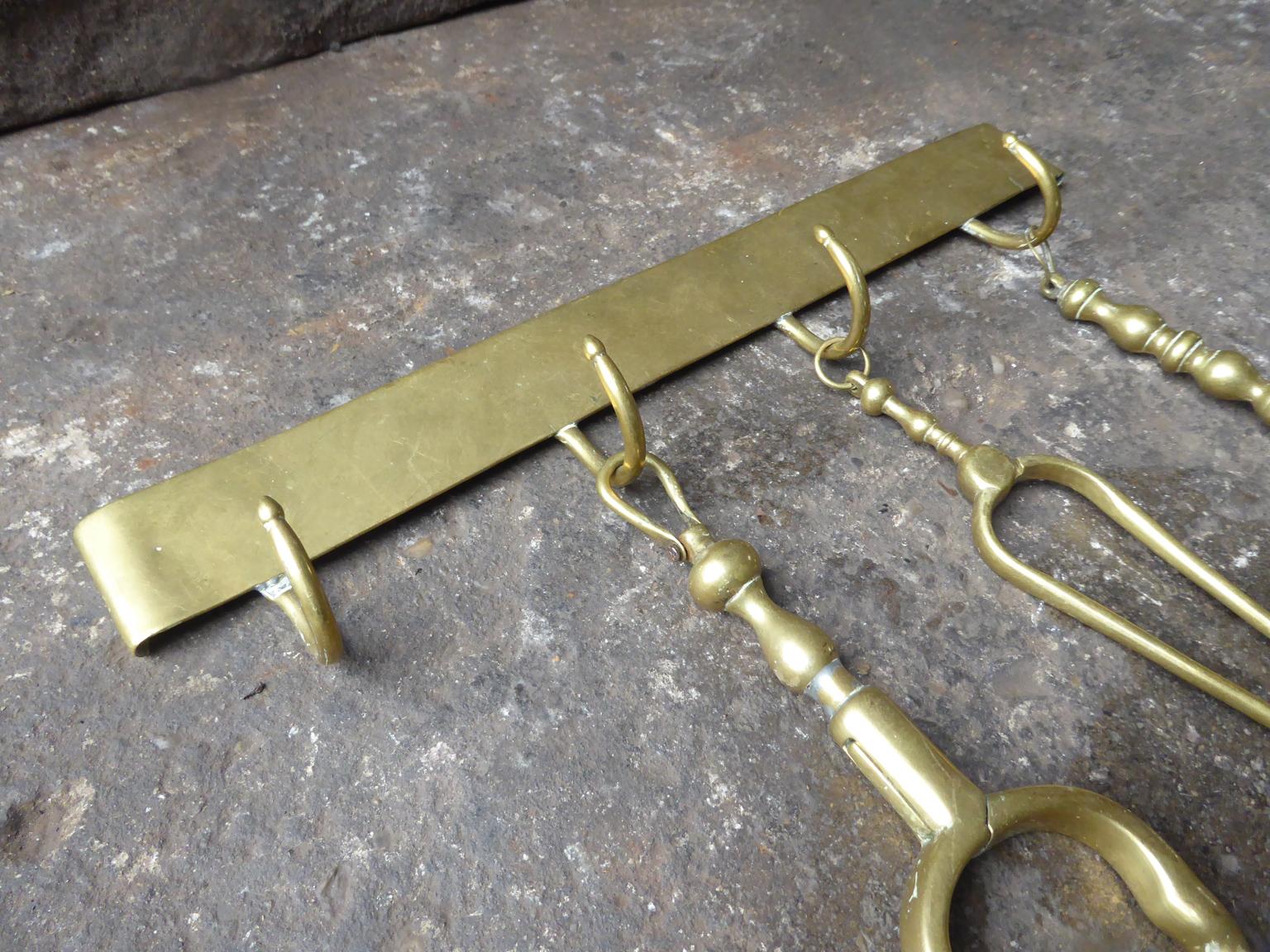 Set of 18th century Dutch fireplace tools with a hanger. The tools and hanger are made of polished brass. They are in a good condition and fully functional.







