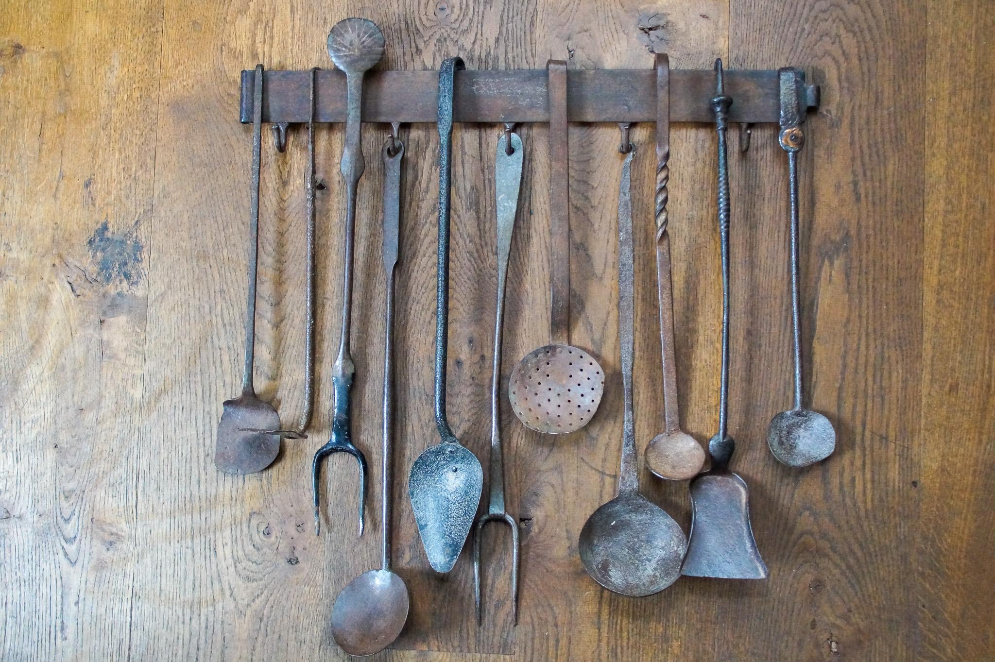 18th - 19th century Dutch neoclassical fireplace tool set consisting of two tasting forks (of which one decorated), 5 spoons, a poke, a shovel, a spatula, several spoons (of which one is decorated) and a hanger. The set is also made of wrought iron
