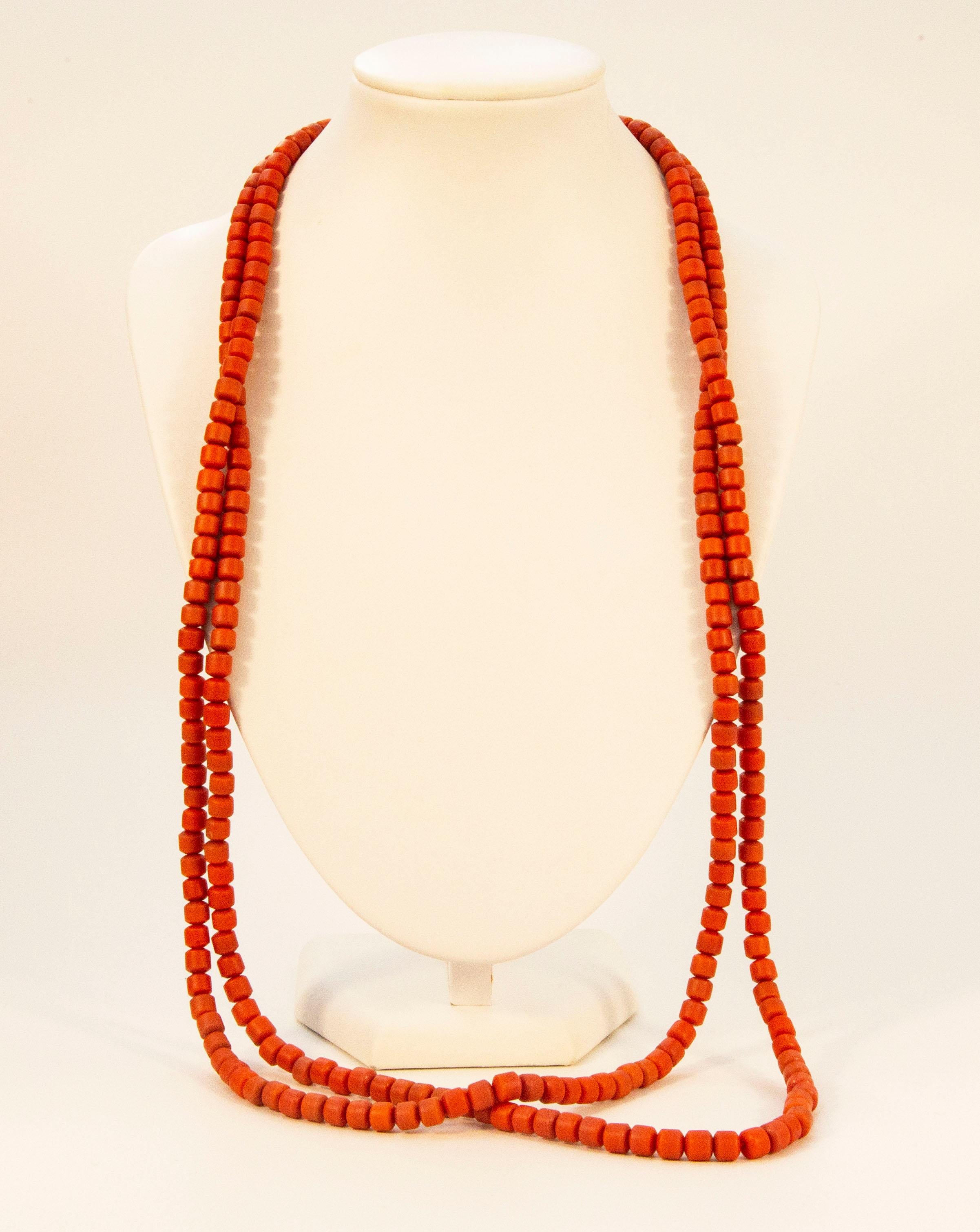 An antique one strand, very long, genuine red coral (Corallium Rubrum*) bead necklace with a brass barrel lock. The necklace was made at the beginning of the 20th century in the Netherlands. The coral beads are not dyed and the necklace was