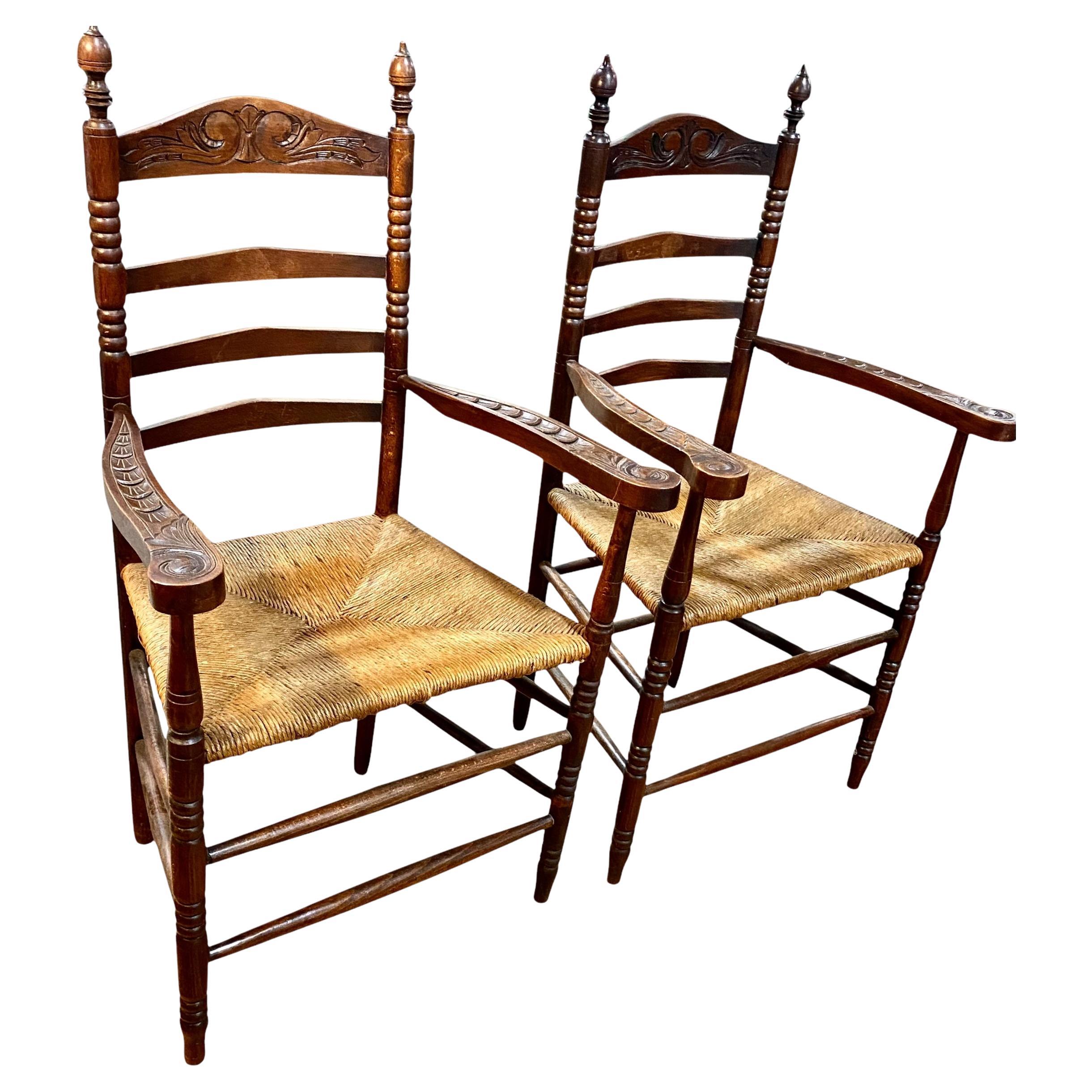 These charming antique Dutch carved oak ladder back chairs featuring rush seats make an excellent choice for enhancing the ambiance of any living space. Combining style, comfort, and durability, they are versatile additions that will elevate the