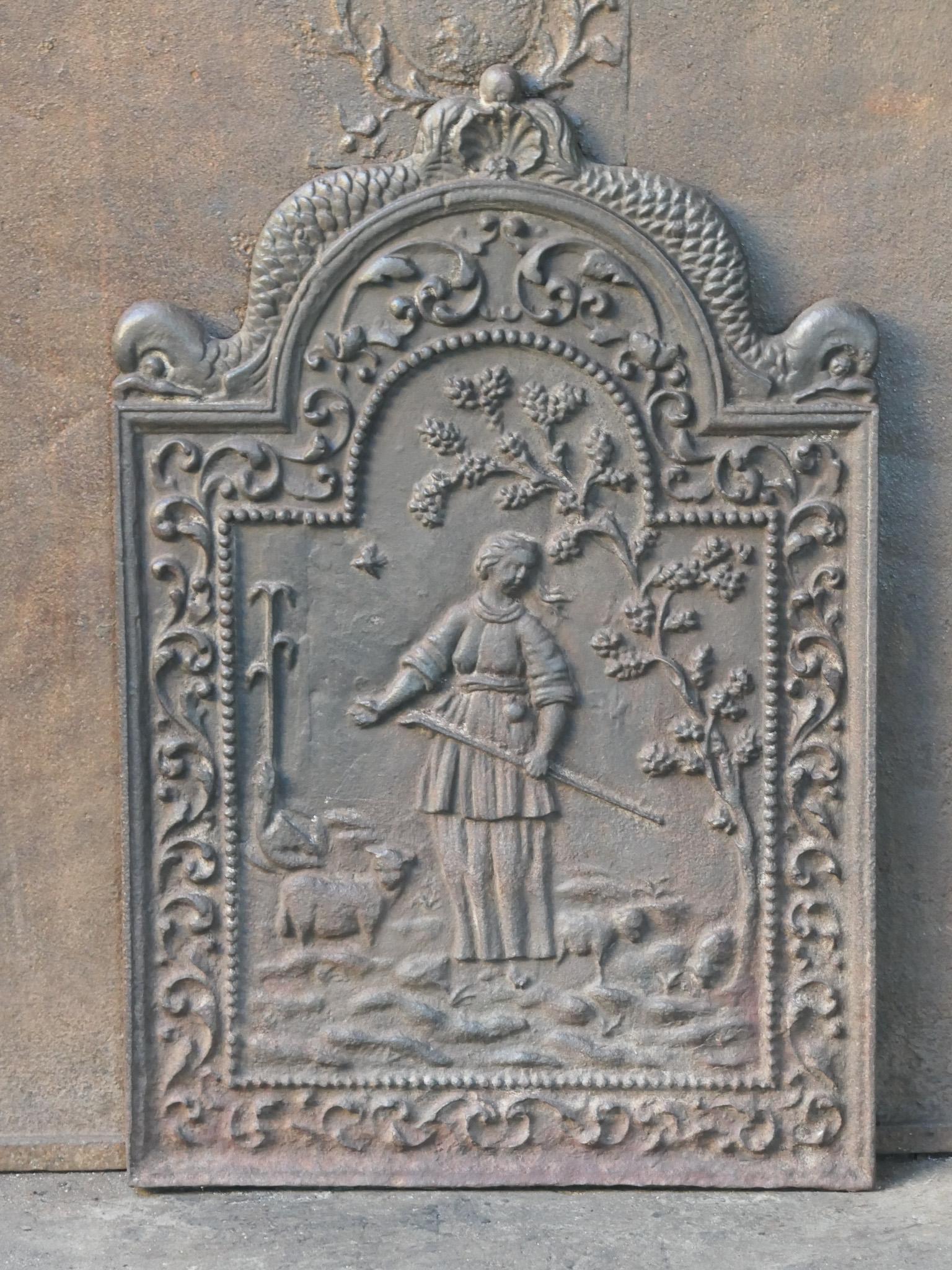 17th - 18th century Dutch fireback with a shepherdess. The style of the fireback is Louis XIV.

The fireback is made of cast iron and has a brown patina. Upon request it can be made black / pewter colored at no extra cost. The condition is good, it
